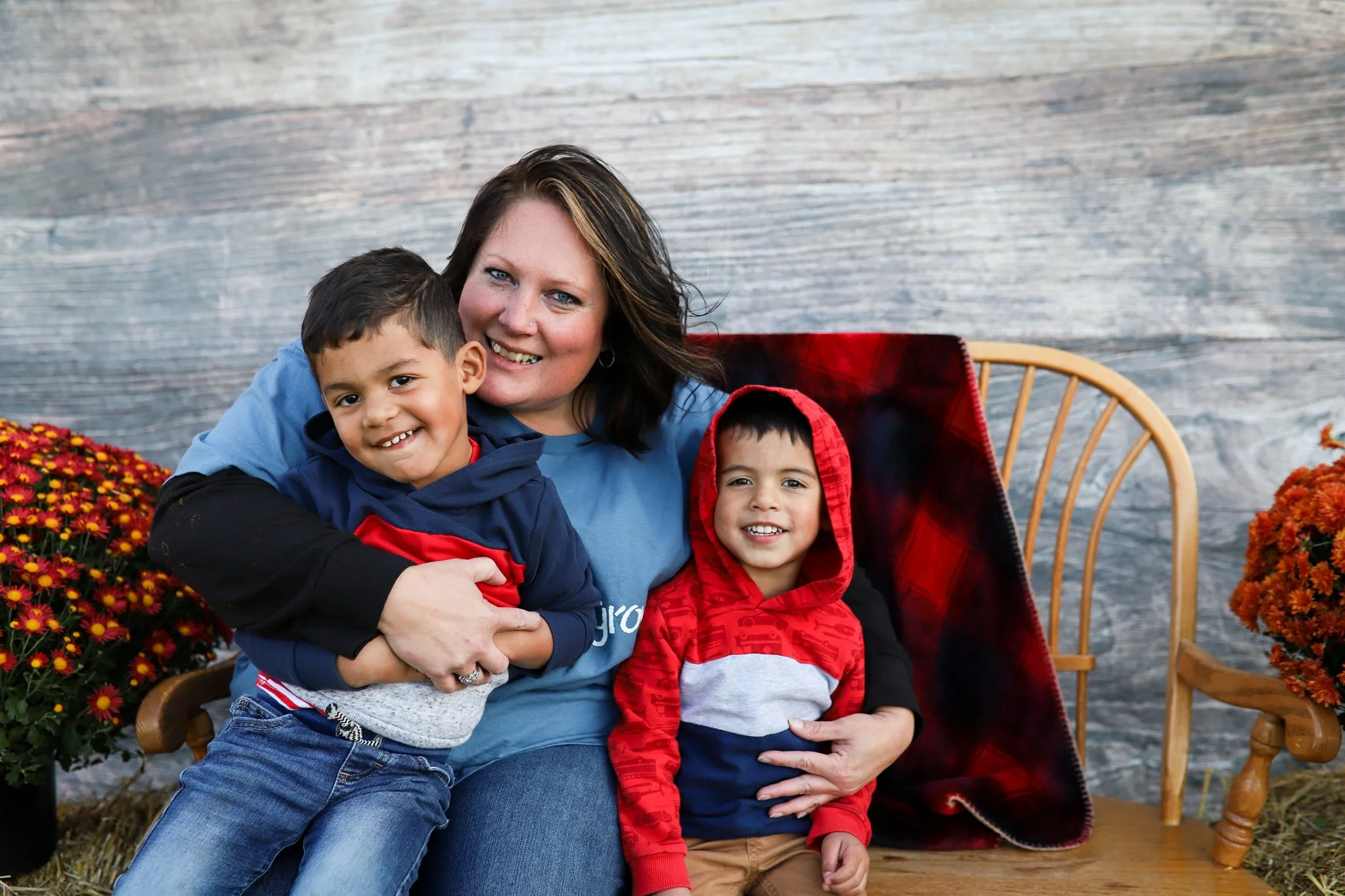 mother with her two young boys smiling at camera