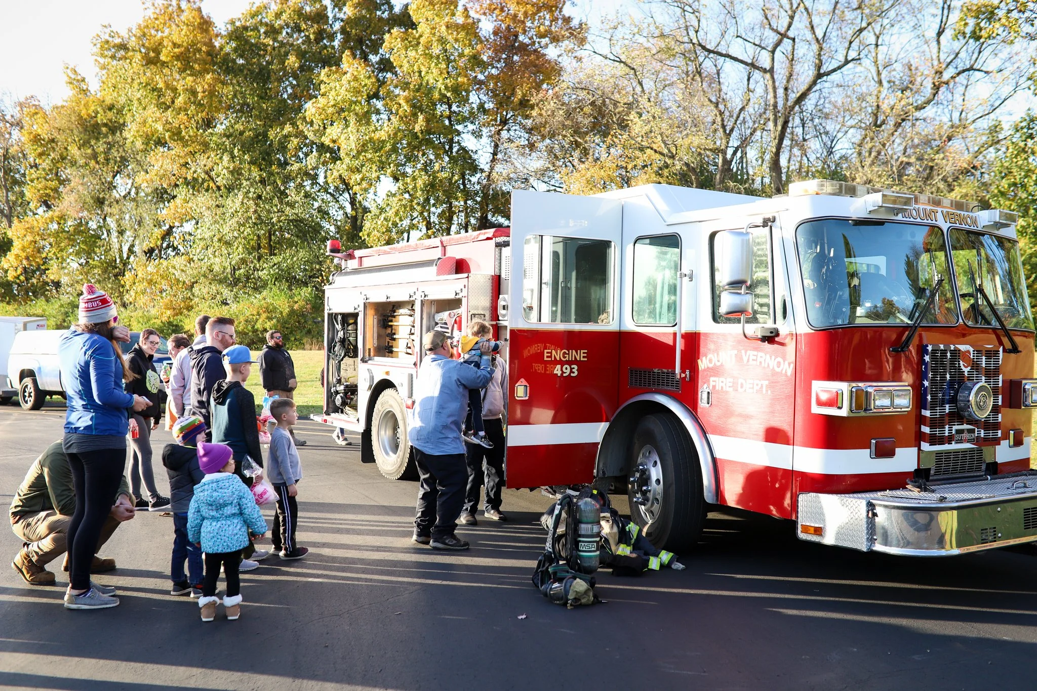 group of people looking at fire truck