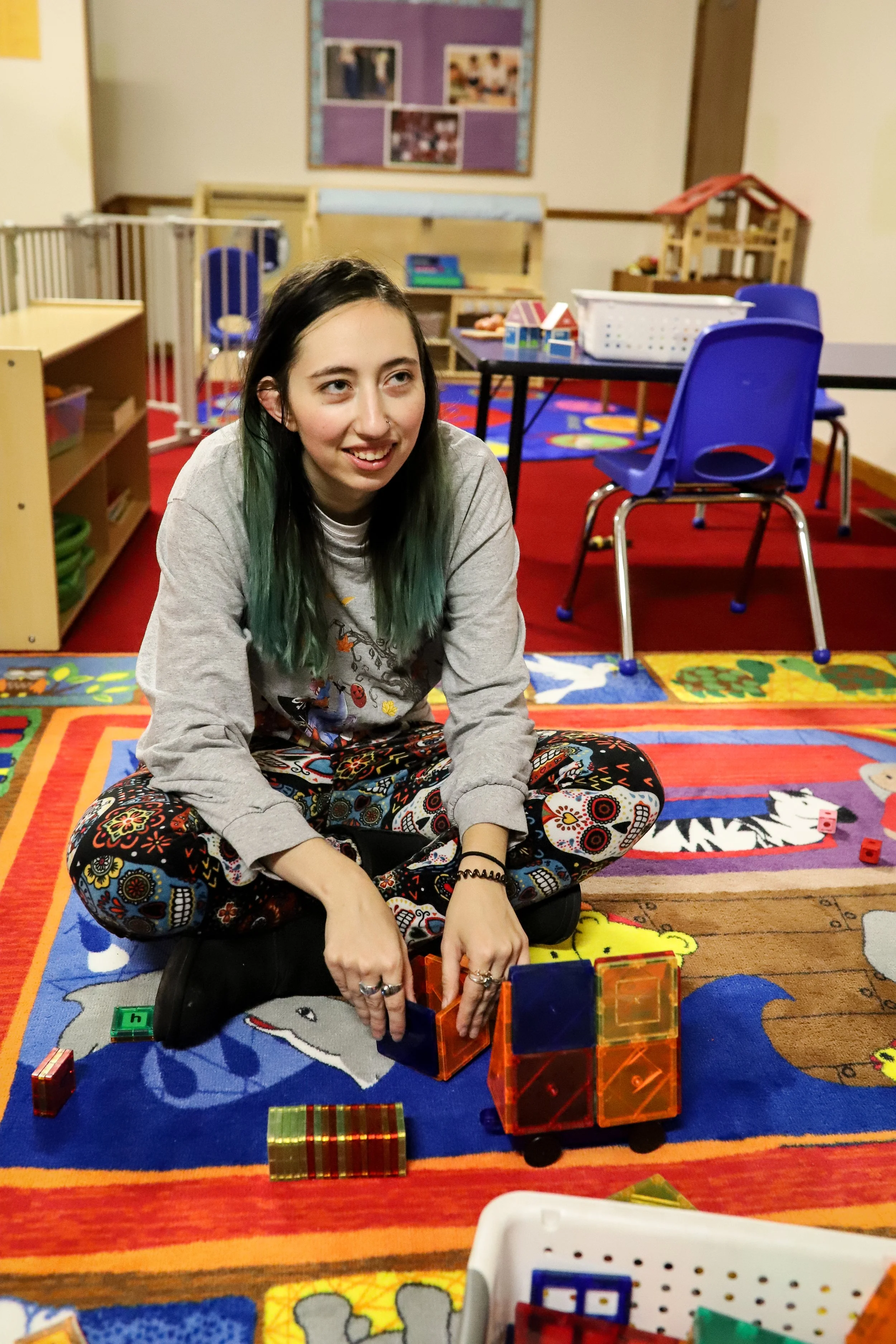 young woman with disability sitting on the floor smiling
