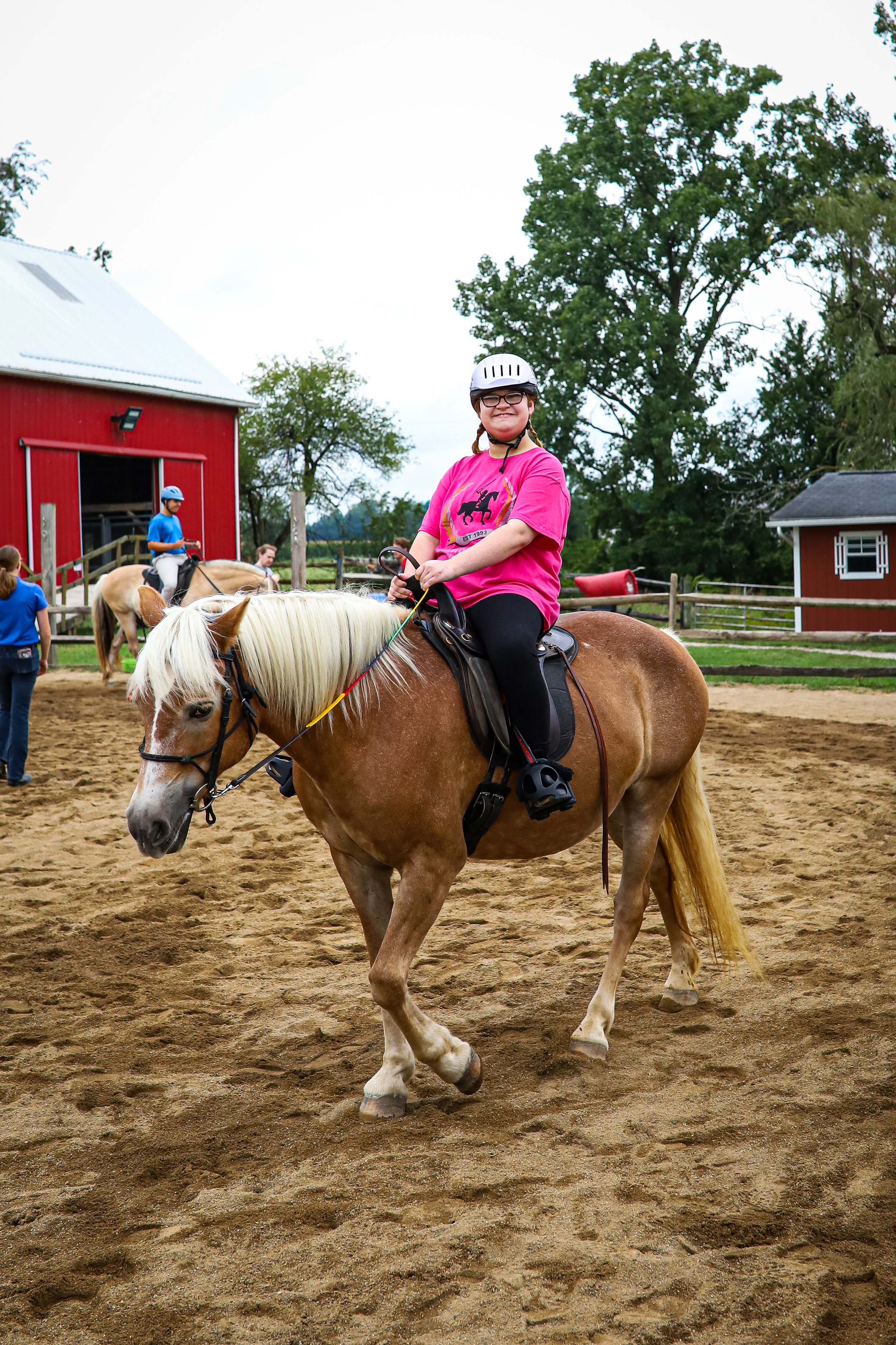teenage girl with disability riding on a horse