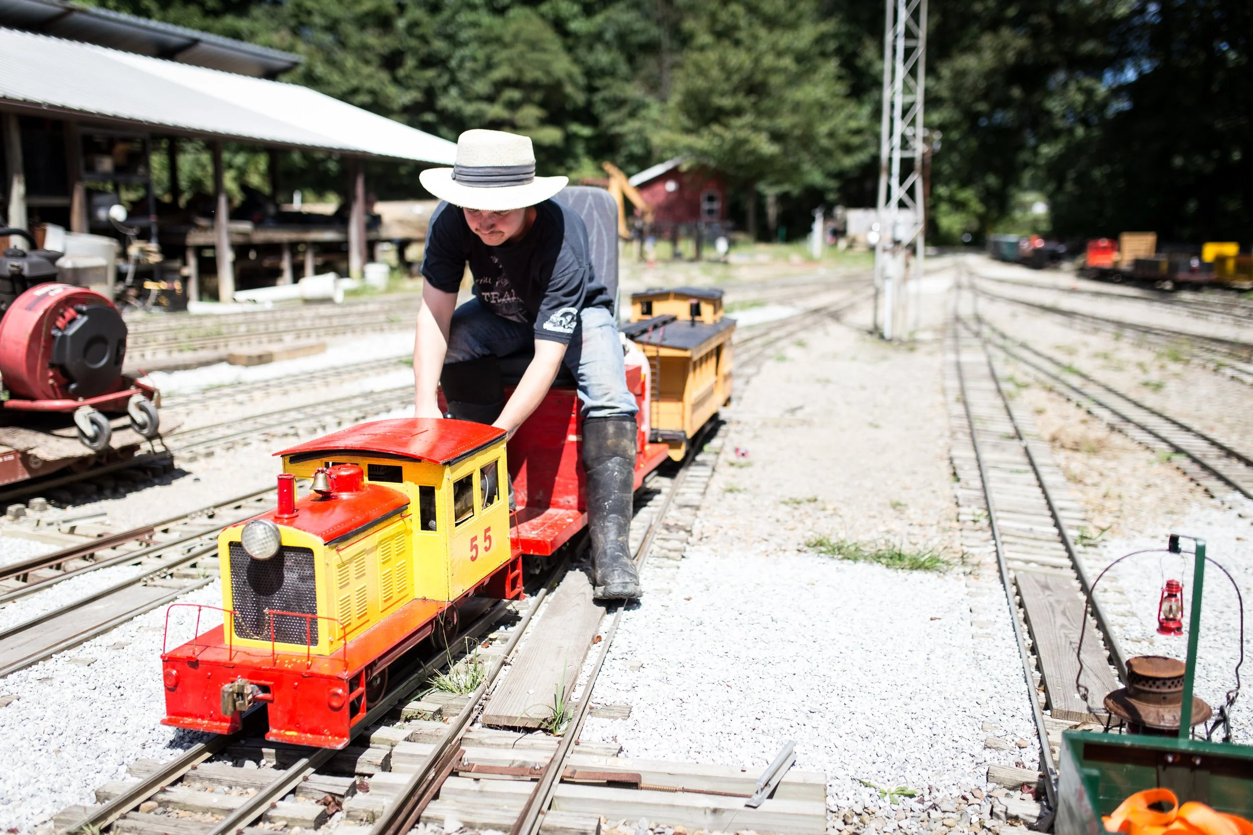 young man sitting on miniature train