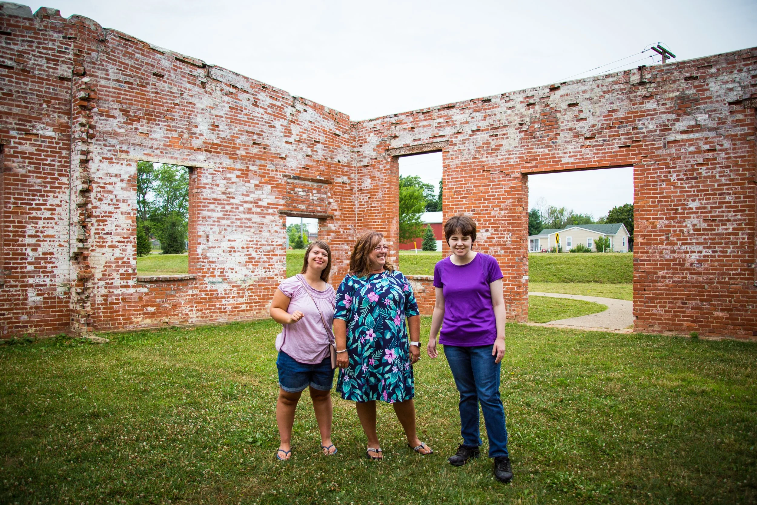 three women standing together smiling for the camera