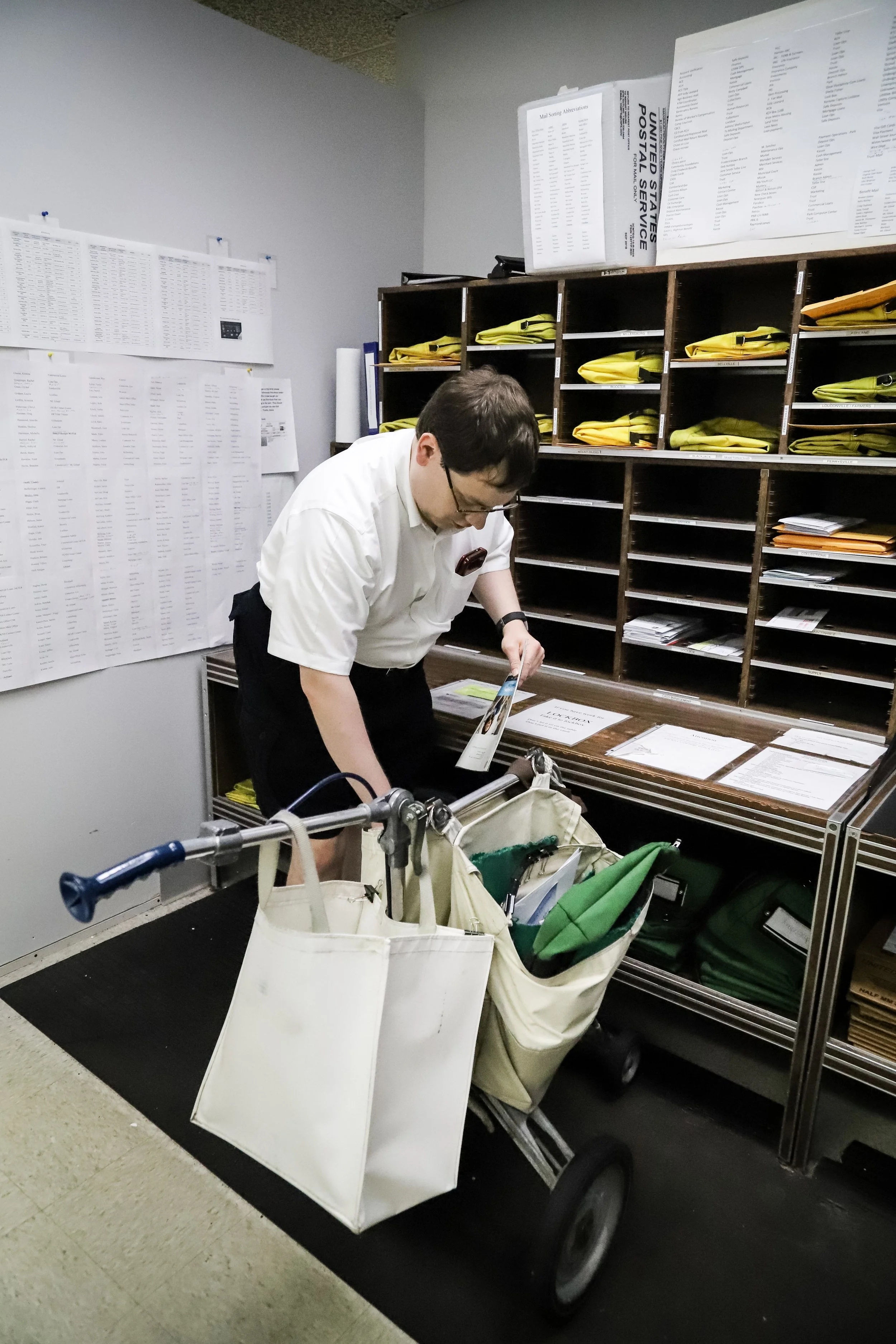 man with disability sorting mail at his job