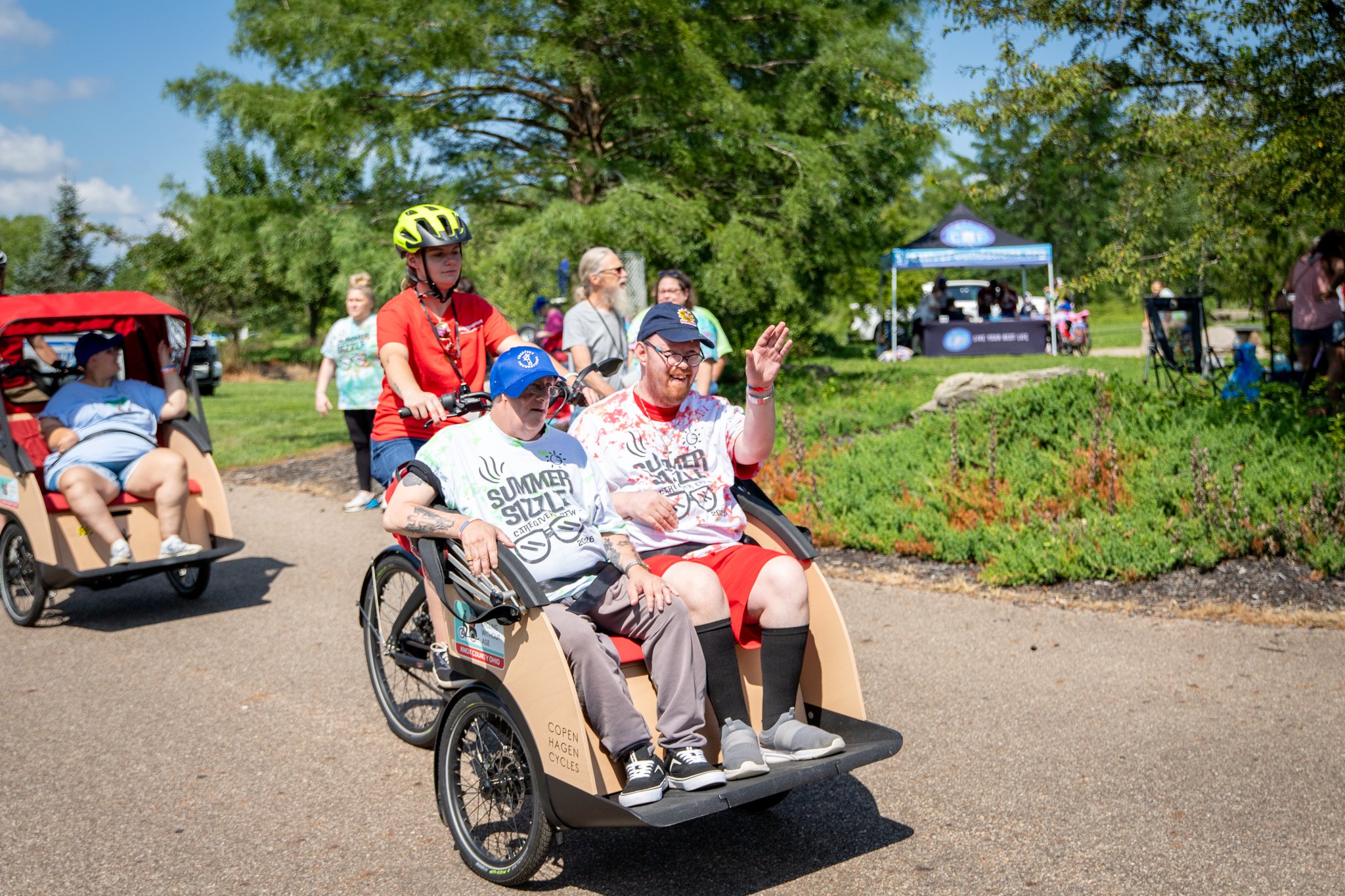 two gentlemen riding on a happy spokes bike