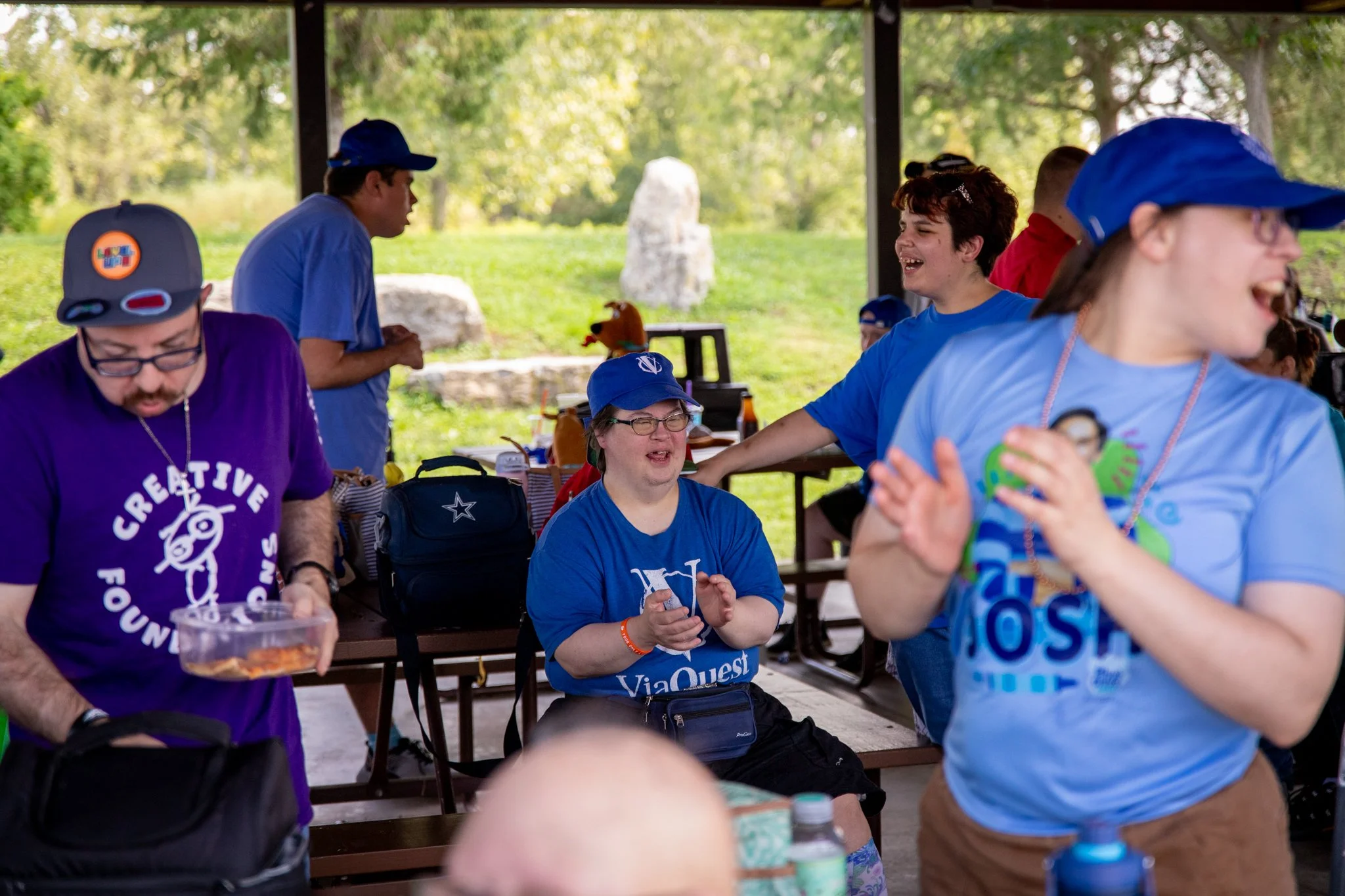 group of people smiling and clapping together