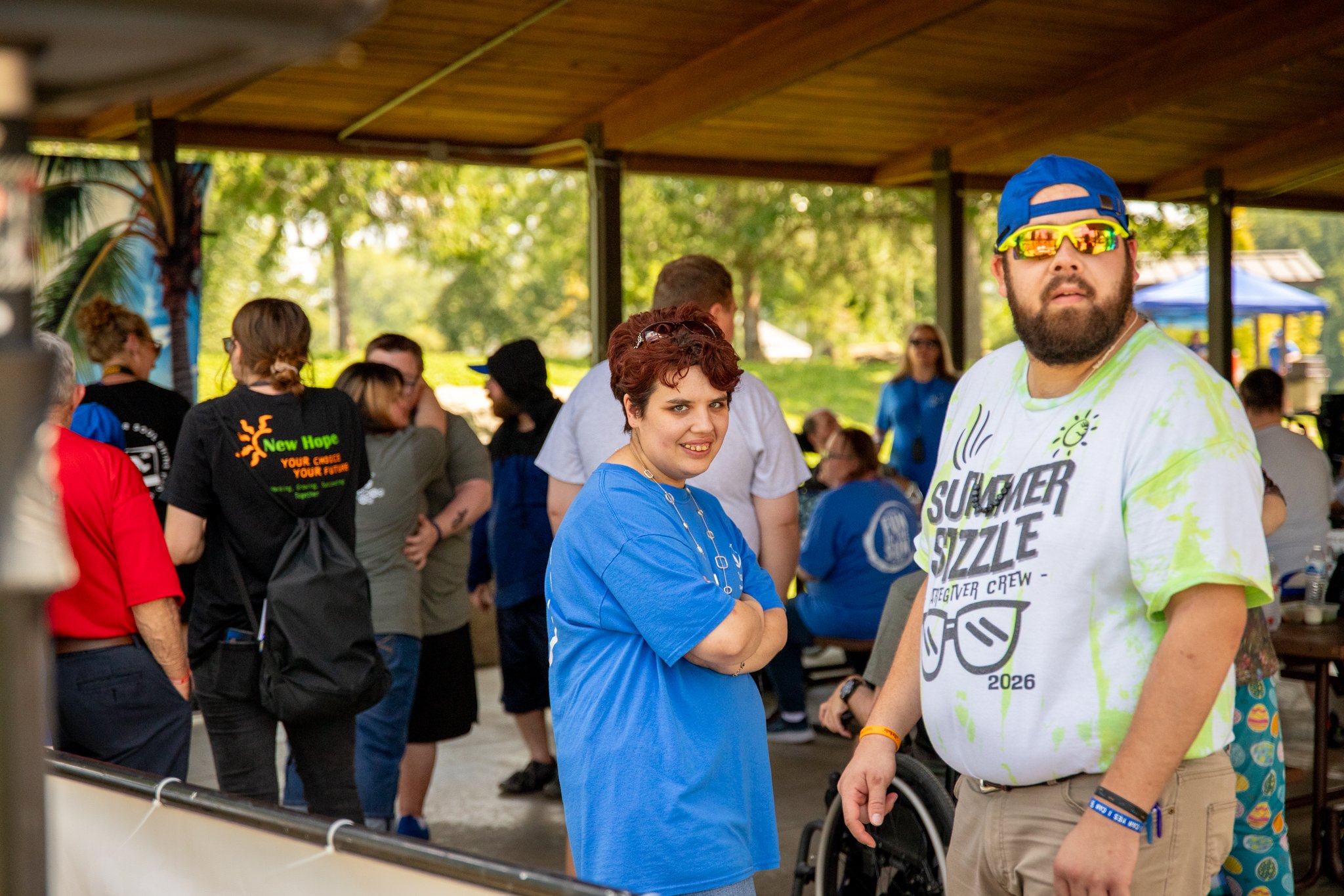a man and a woman standing together at a large gathering
