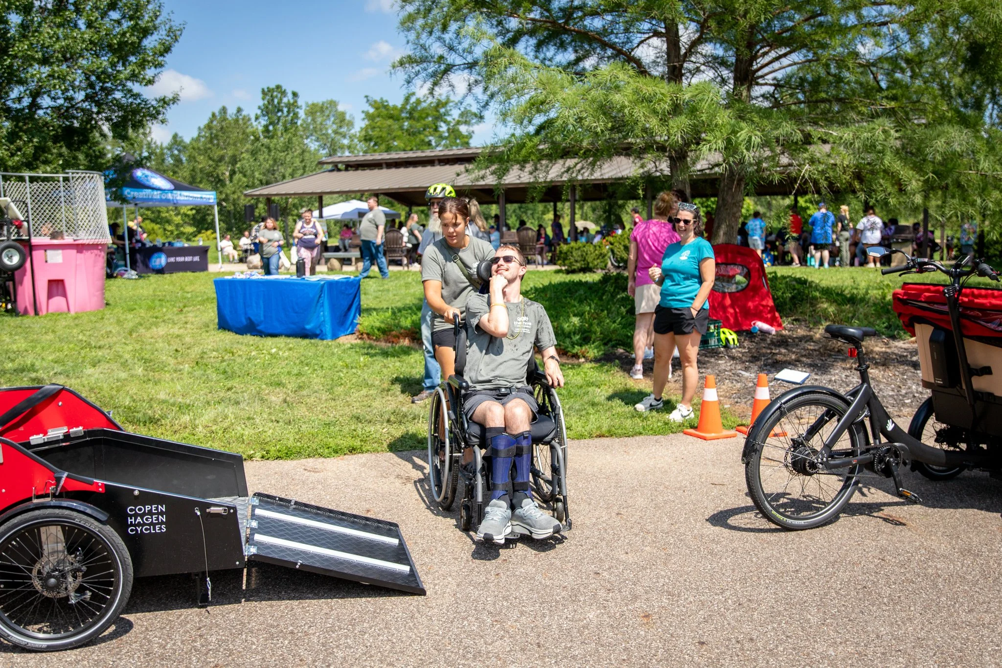 young man in wheelchair, preparing to ride on a happy spokes bike