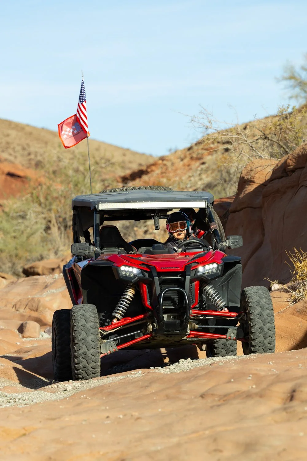 Casey Corderio navigating through the desert wearing the Cardo Packtalk Edge Open-Face Helmet Kit