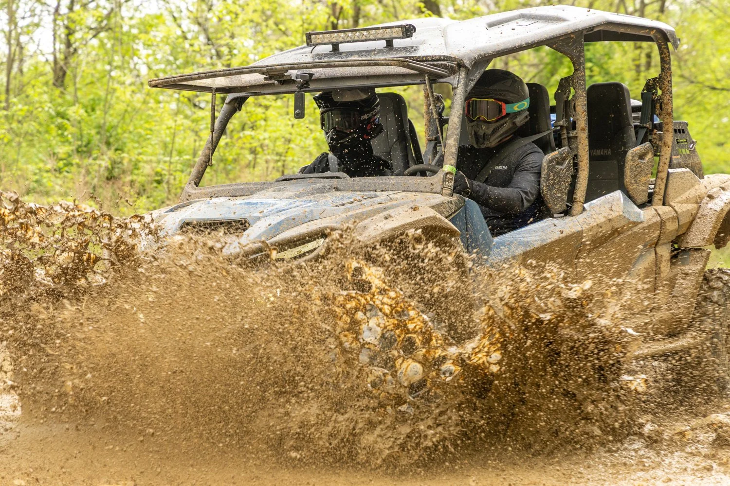 Riders equipped with Cardo Packtalk Edge Helmet Kits in the Yamaha RMAX4 1000 blasting through a puddle