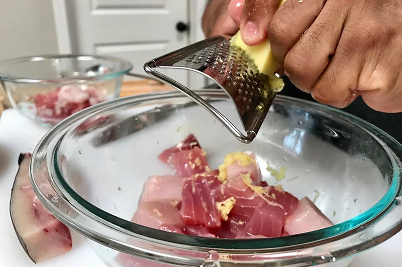 Chef Jayps grating ginger.