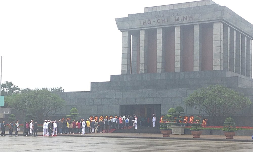 Ho Chi Min lying in eternal state. Guarded by the white uniformed police