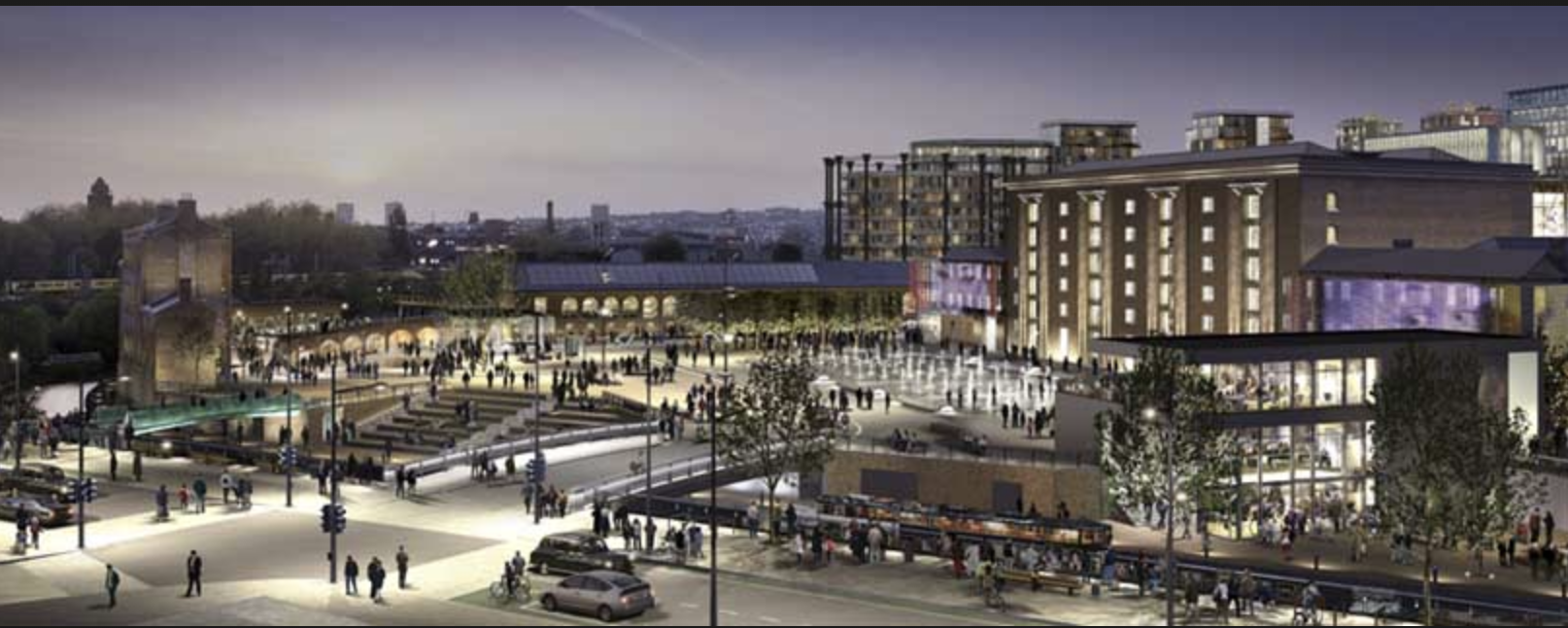 A night time view of Granary Square, part of the Kings Cross development. The circular structure in the background is one of the blocks of flats built inside an old gas tank frame