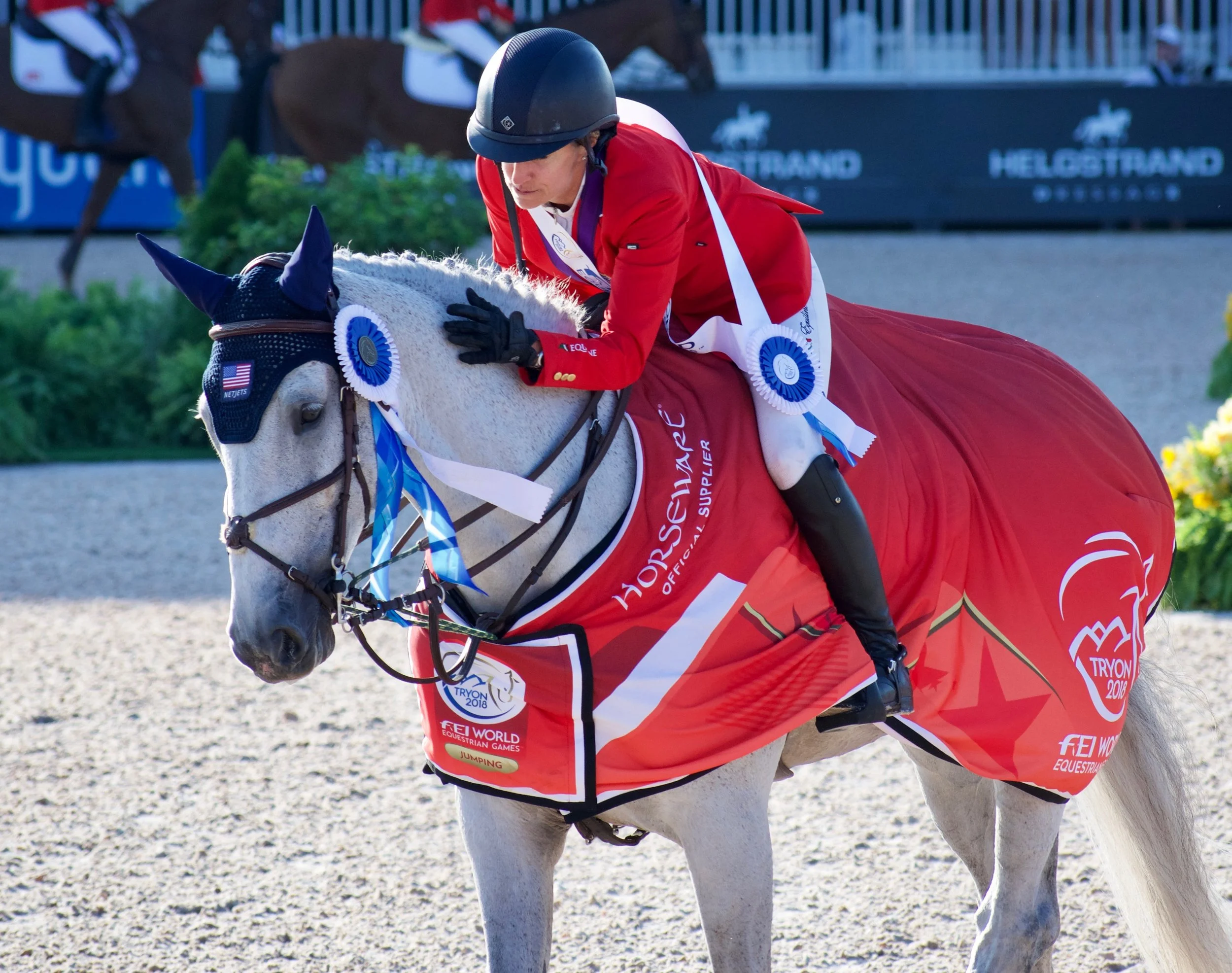 Laura Kraut riding Zeremonie shows appreciation for her equine partner after winning the team Gold in show jumping at WEG 2018. pc: The Tech Equestrian