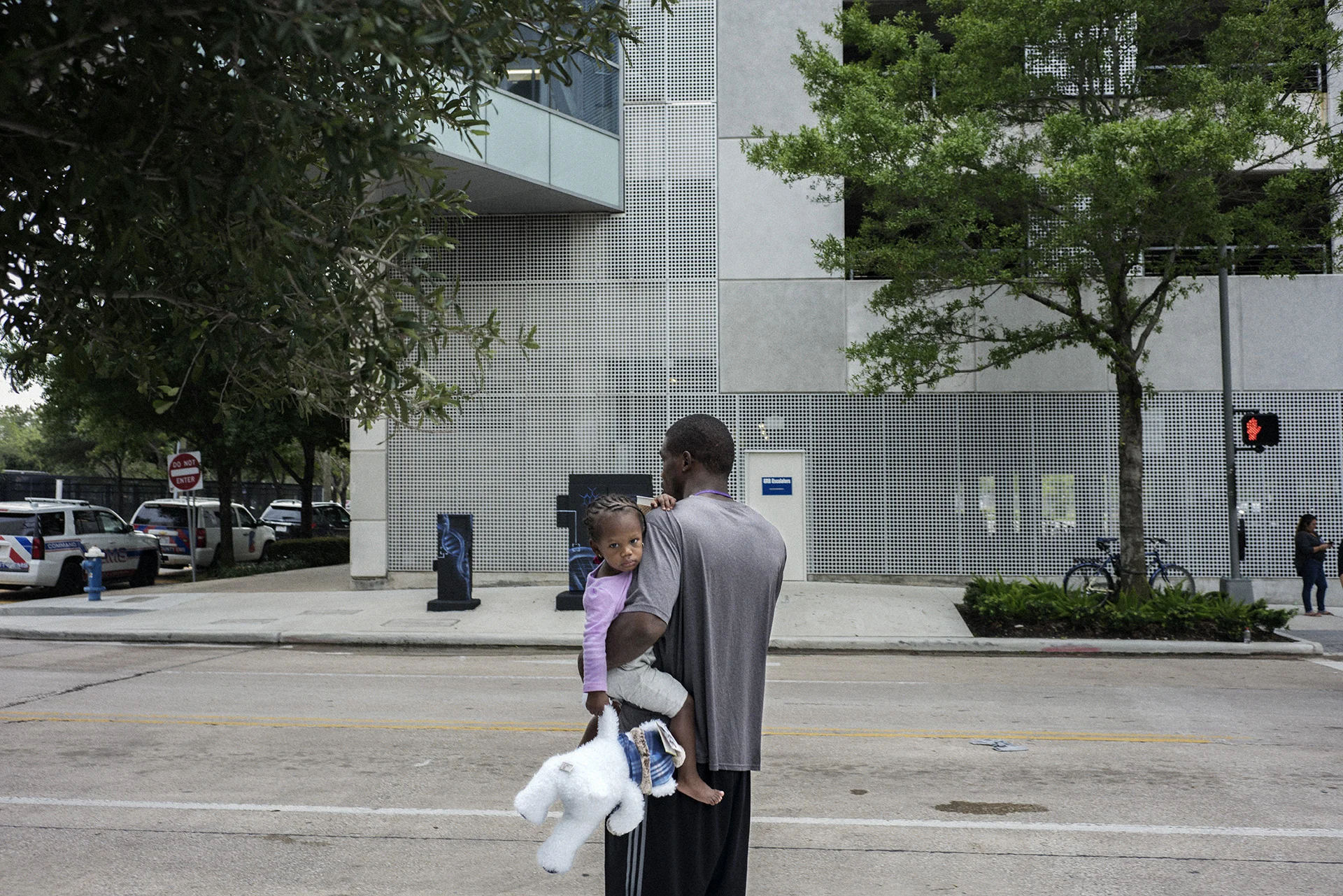 A little girl and her father outside of the Houston Convention Center.
