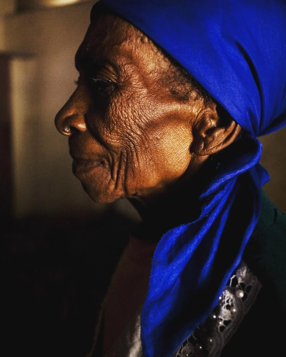 January 13, 2018 Haiti remembrance, day 2 Coming to you here for the second day with photos to remember #Haiti on the anniversary of the #2010earthquake and to address the troubling words coming from the United States president. From yesterday’s young to today’s elderly post—for both I was drawn to their dignity and strong spirit. Both were also taken in really hard places. This was the Azil St. John De Dieu home for the elderly in Petit Petit Goave, Haiti. To say that the people there had few resources is an understatement: the elderly at St. John were basically left to fend for themselves. In 2011 I wrote of the home: “Those with sight lead the blind. When someone comes down with a fever they are looked over with kindness by women who have tended to sickness all their lives. A cripple from the waste down uses his arms and hands to feed a man who is crippled from the waste up.” Life is difficult for the elderly in Haiti period, but after the earthquake resources were stretched thin and getting by was even more difficult for them. But they cared tenderly for each other. I was drawn to how this woman and others around her kept themselves up, their way of dressing was a statement within itself. With so much in ruins all around them they kept an elegant dignity with the small little things that they had to dress themselves, they expressed themselves by dressing in accordance with their inner dignity.
