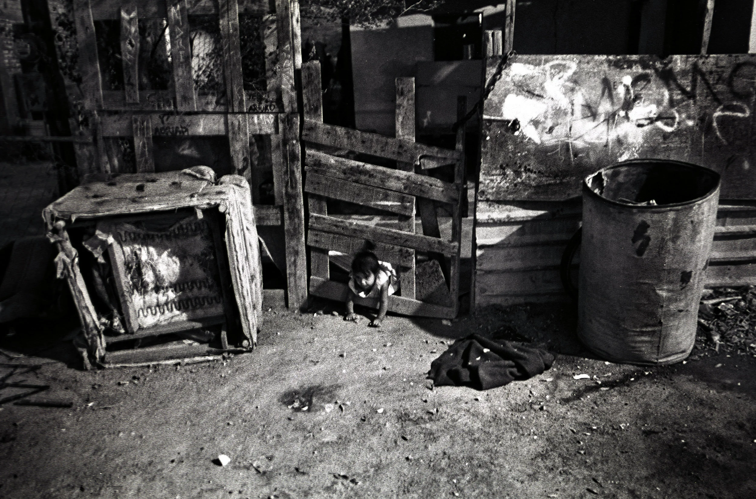 A little girl plays in front of her house in the Colonia Robledo, a poor neighborhood in Mexicali that sits next to several industrial parks.