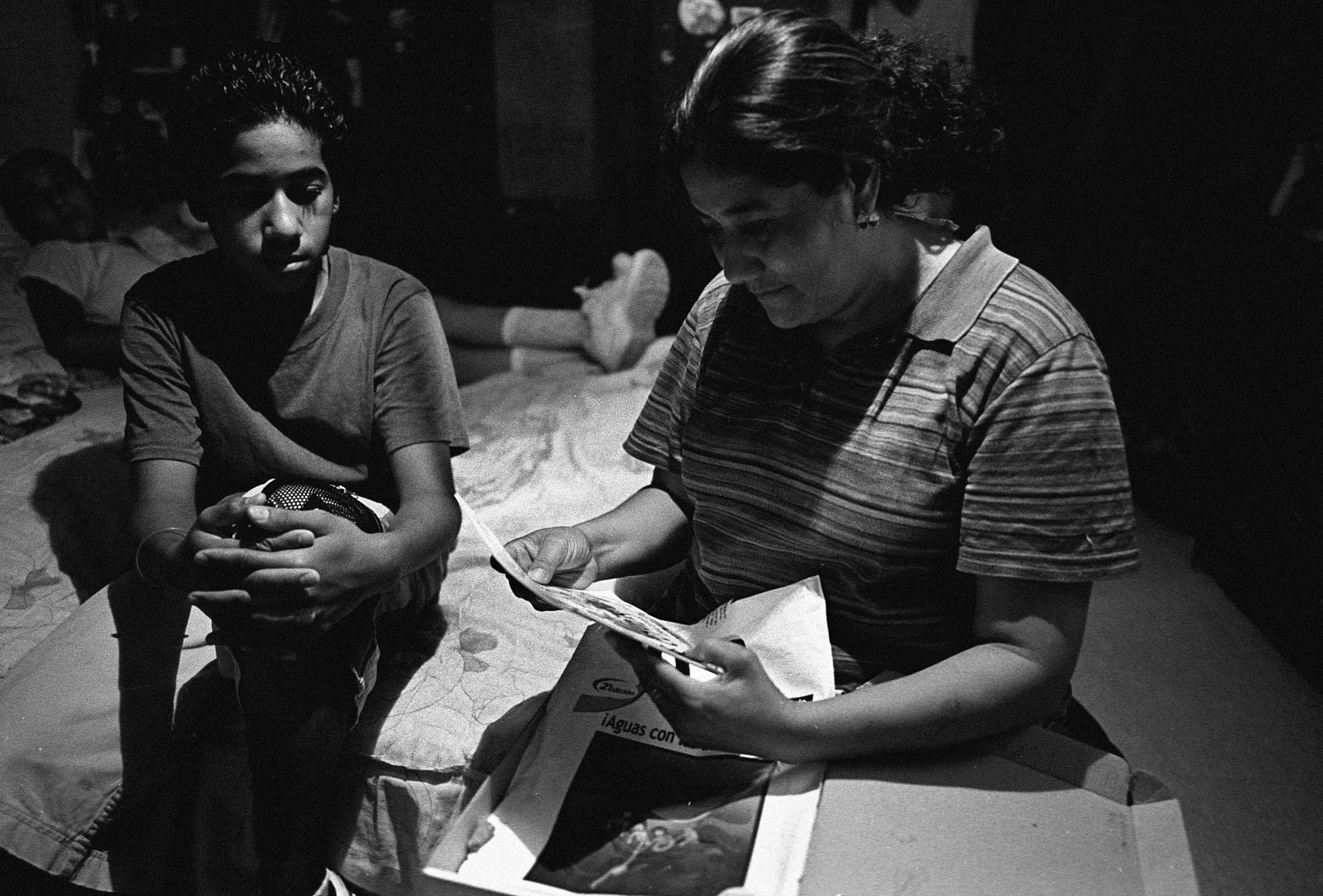 Lidia Orozco, 35, mother of 2 in the Colonia Robledo, in Mexicali that sits next to several industrial parks. She is looking over learning materials for a class she plans to take at a nearby college. “This place is a mess, a dump. The streets are unpaved and the dust is filled with chemicals. We may be poor, but we don’t want this factory trash here. It affects me. I cough and have asthma. I think that the municipal government is responsible for looking after what the factories throw out in the air. I’m not sure. I’d like to see a vocational school open up here instead of a factory. There’s nothing like that here. Before NAFTA there were fewer cars. You could count them pass by on the street. Now there are so many. Sometimes we just laugh at how much it’s changed. I don’t understand NAFTA very well."