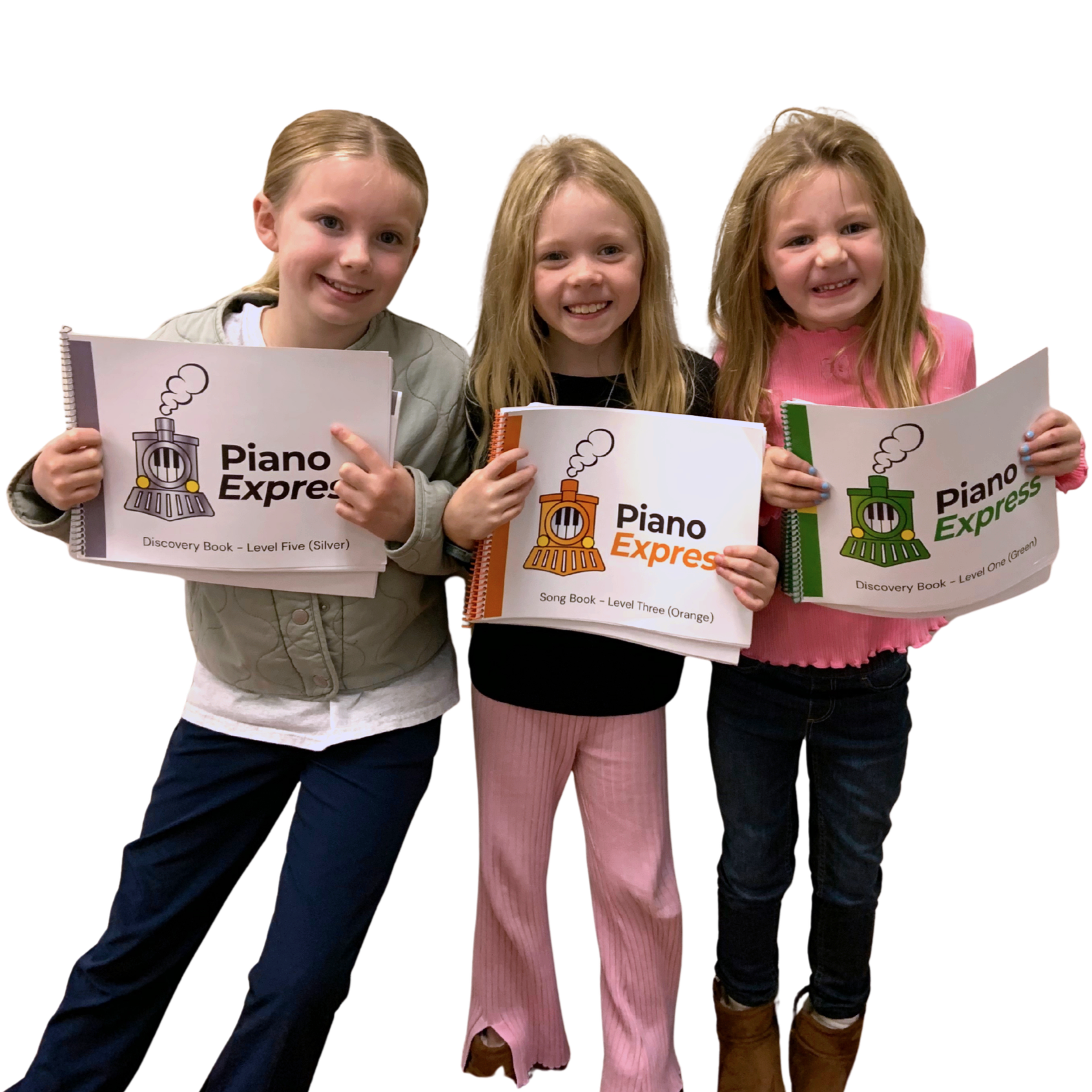 Three young girls holding Piano Express music books, smiling and standing against a plain background. They are having fun learning to play piano. They have progressed quickly through their books much faster at Farmhouse Music Studio.