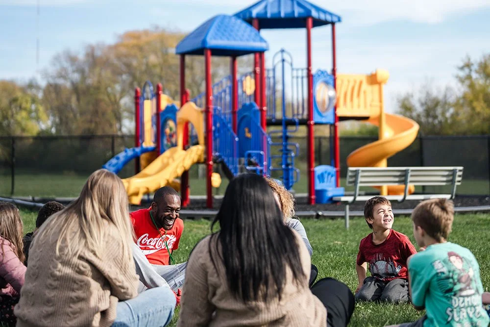 a group of kids and teachers at a park