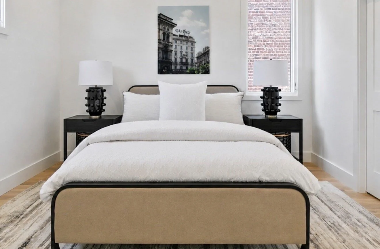 Luxury primary bedroom with upholstered bed and modern neutral staging at 2 N Brunswick St Richmond VA by Jsquared RVA