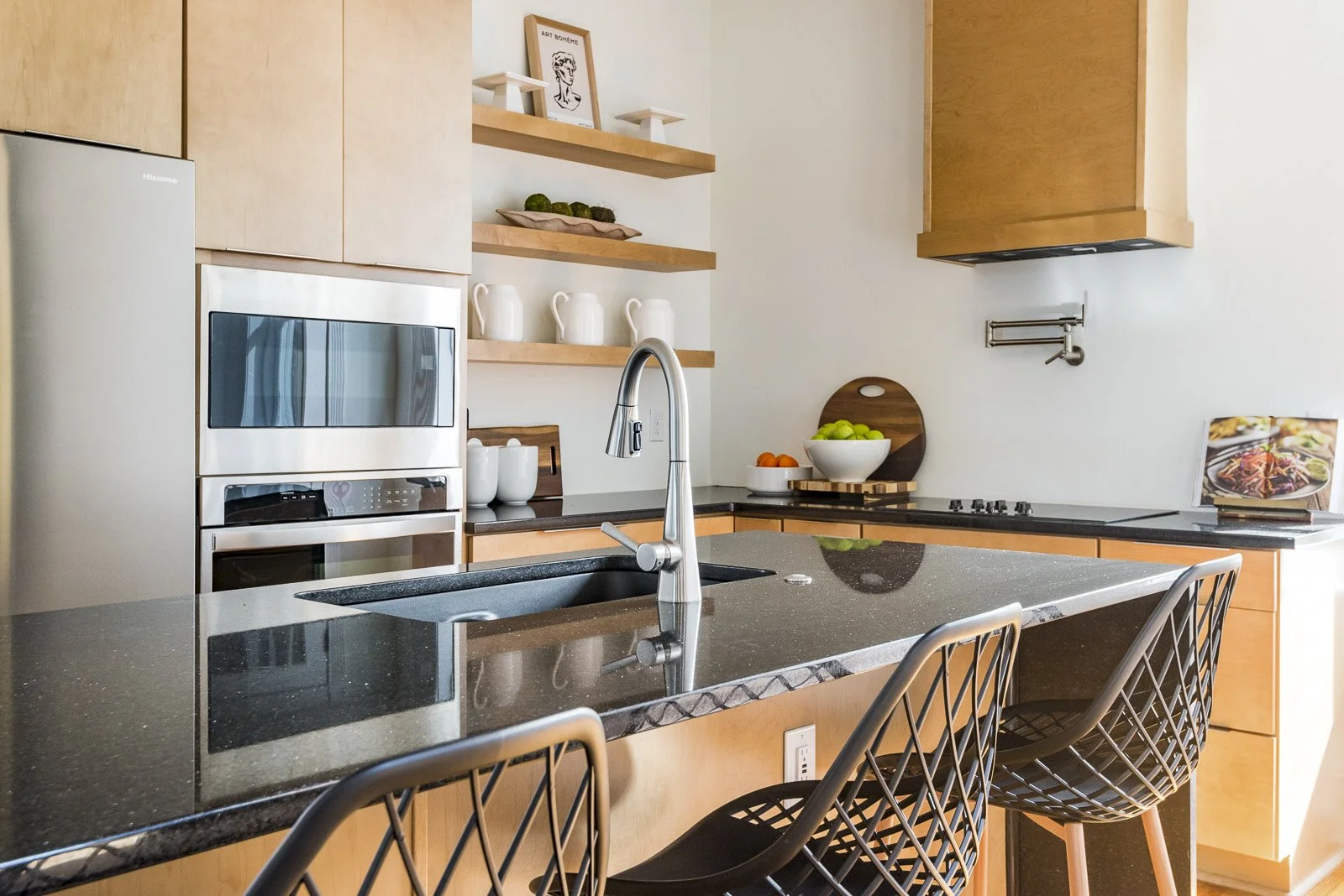 Modern kitchen remodel in Richmond, VA featuring black quartz island countertops, custom cabinetry, and open shelving by Jsquared home staging