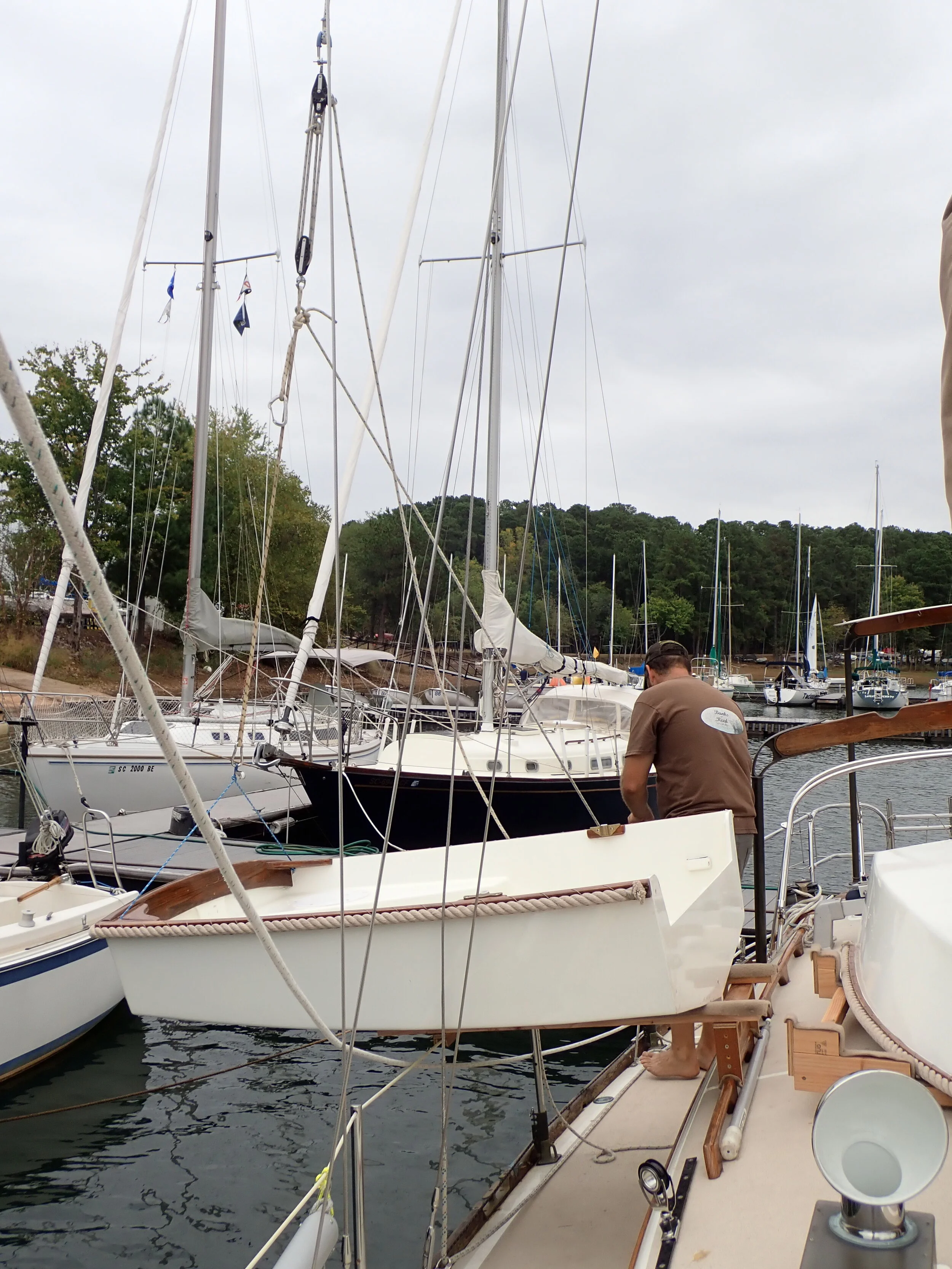  Step #7  There still is a reasonable amount of weight on the lifting system at this point.  We tie a line to prevent the stern section from swinging forward, without this the it will try ti swing into the mast. 