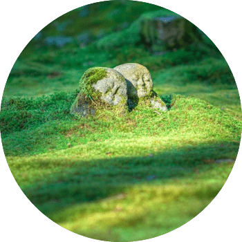 moss covered stone figurines