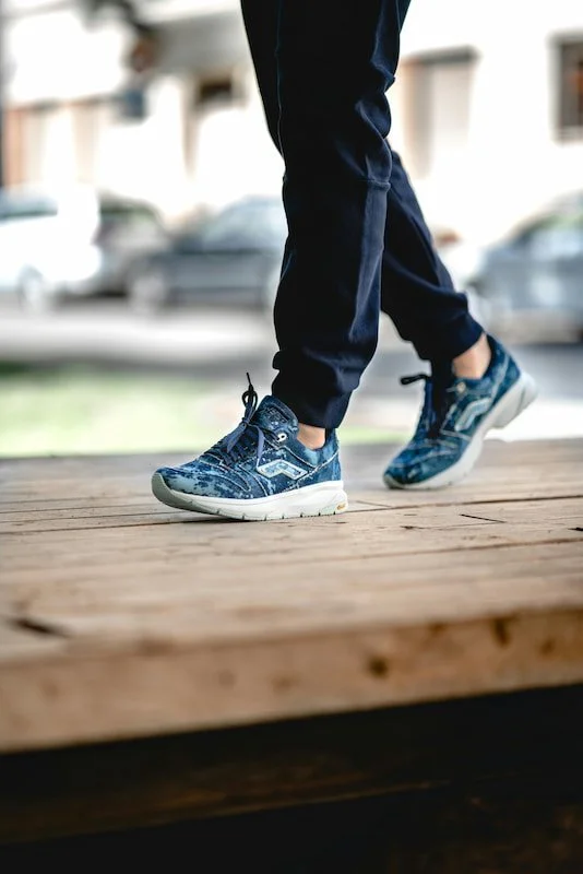 a person walking and a close up of their shoes