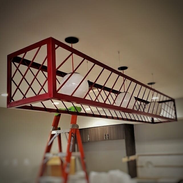A couple of work in progress shots from a local job. A custom steel light fixture and a raw steel door casing.
