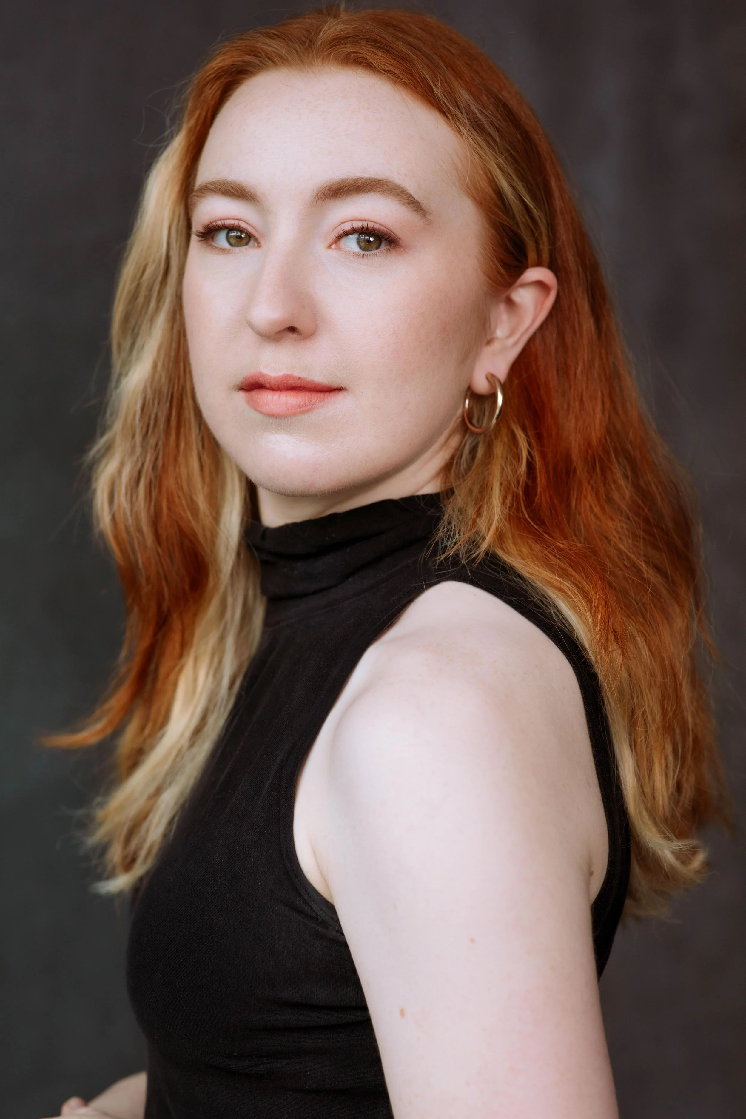 A photo of a young white woman with red hair and green eyes. Photography by Jaclyn Vogl