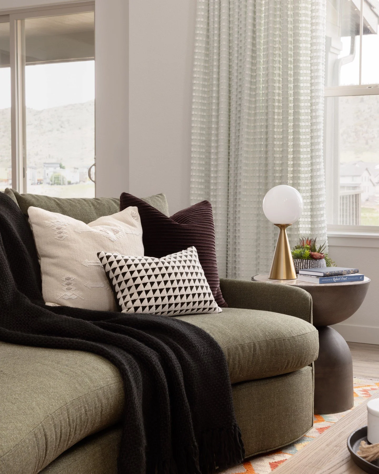 When a new build hands you a blank canvas, you bring the personality.

Quaker House started with pristine white walls and endless potential. Our goal was to create warmth without sacrificing vibrancy. The custom TV shelving unit anchors the space in 