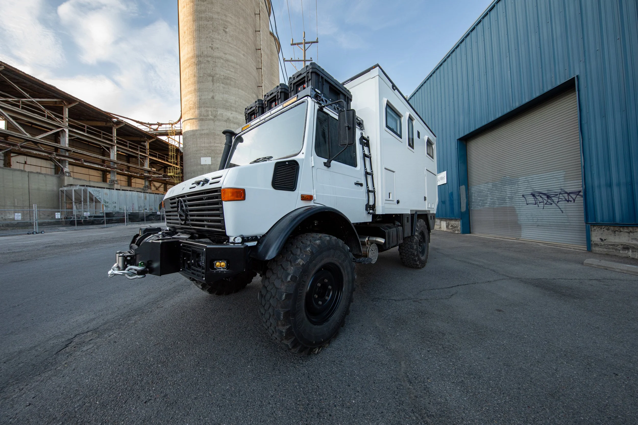 Wide shot of the exterior of a mercedes benz unimog that has been custom built into an expedition vehicle