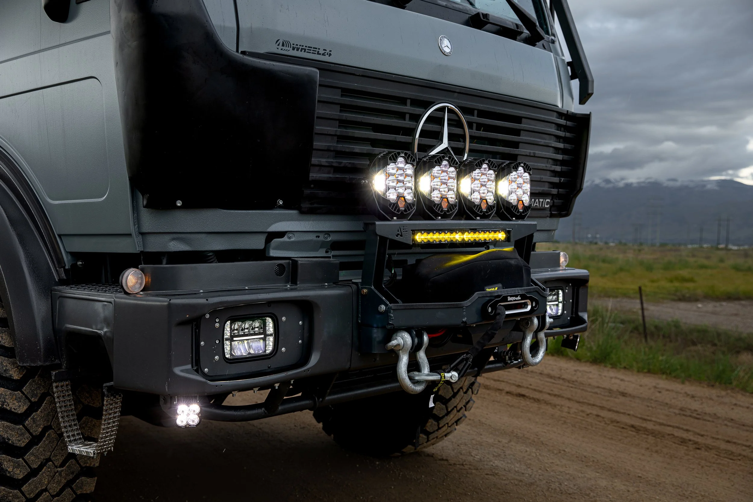 Custom overland mercedes benz expedition truck with a front winch and lights