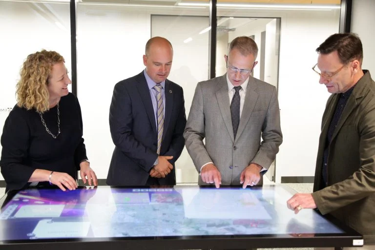 UNSW VP of External Relations, Fiona Docherty, Professor Chris Pettit, chair of Urban Science, minister Fletcher and Professor Bruce Watson, Head of School/Deputy Dean Built Environment interact with the RAISE tool in the UNSW City Analytics Lab. Image provided by UNSW External Relations.