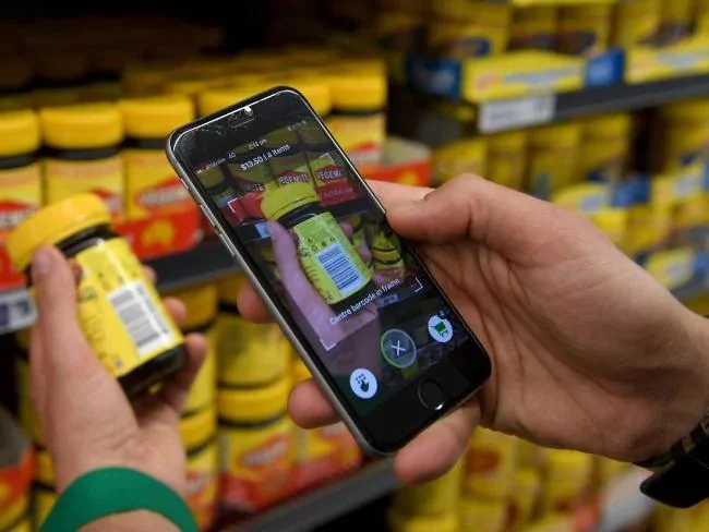 Woolworths employee Bryn Rayfield uses the new Scan & Go app at the Double Bay store in Sydney. Picture: Dan Himbrechts Source:AAP