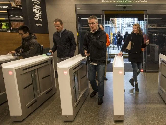 Shoppers scan the Amazon Go app on the mobile devices as the enter the Amazon Go store in Seattle, Washington. Picture: Stephen Brashear Source:AFP