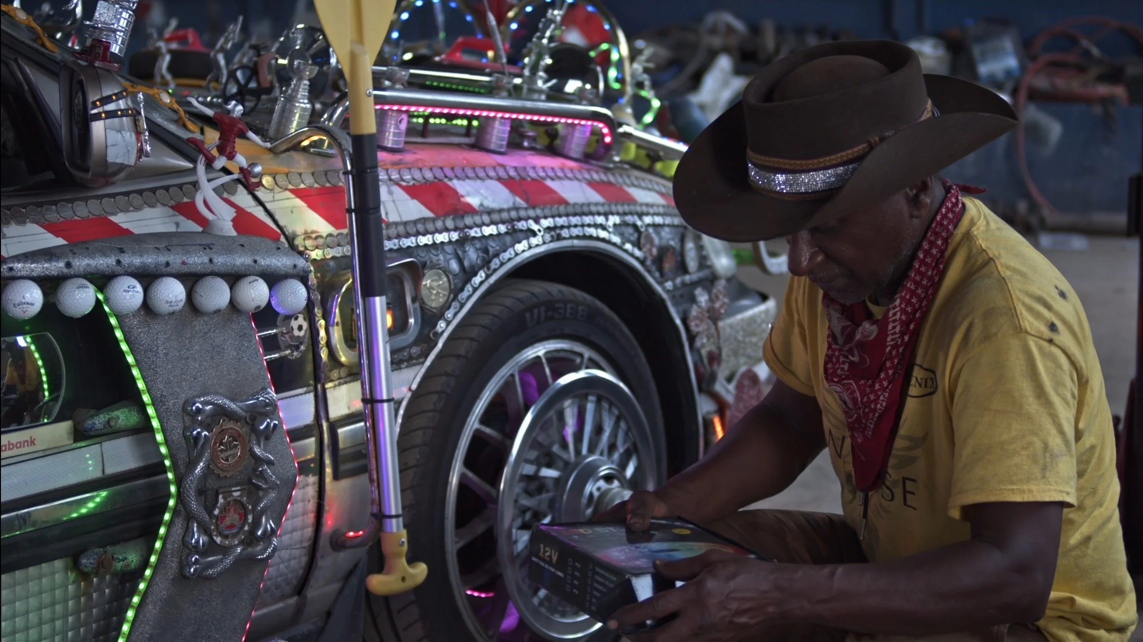 Ismael showing the details of his car in the shop.