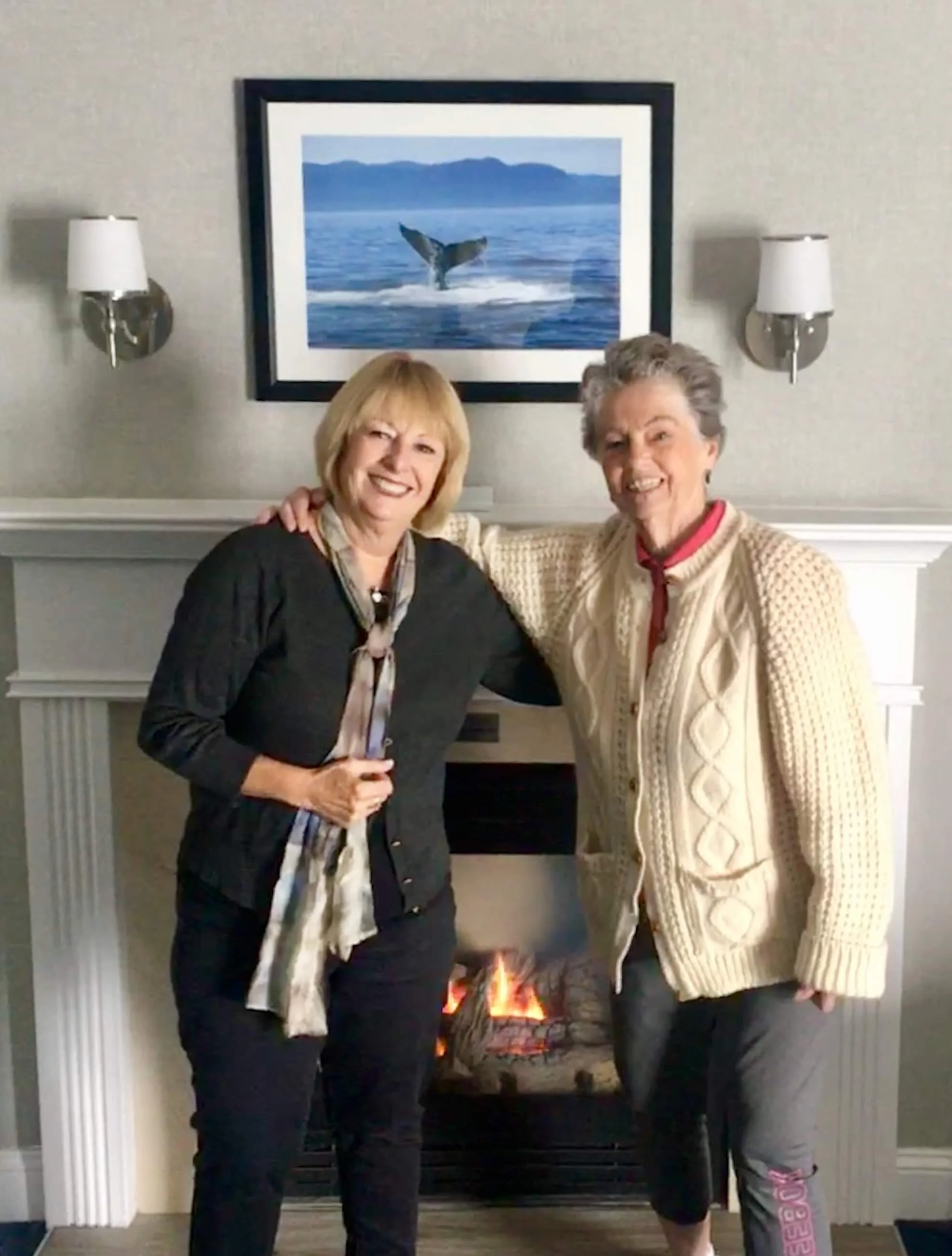 Carol with sister Joan and our inviting fireplace