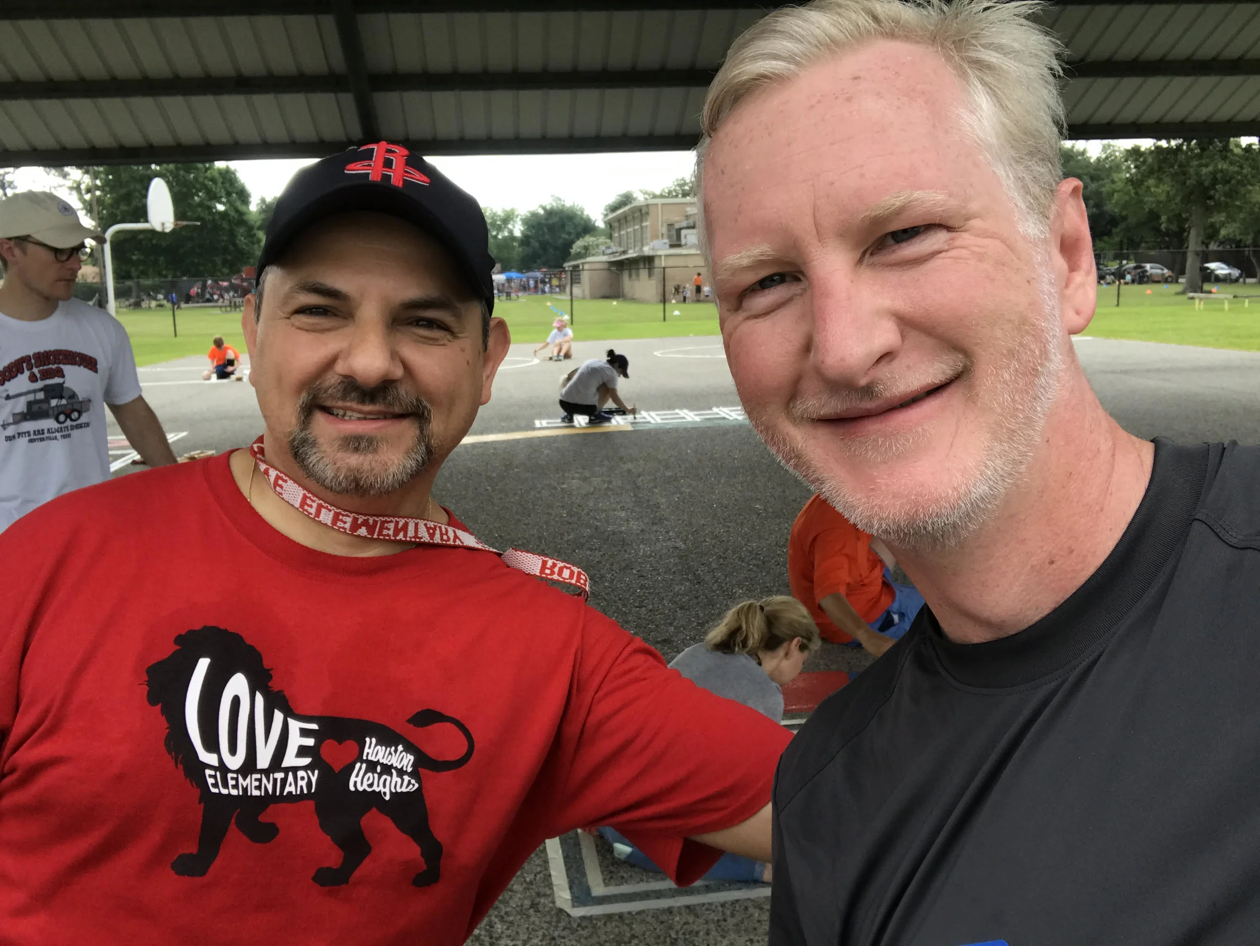 Father David Cumbie of Apostles Houston (right) with the principal of Love Elementary School.