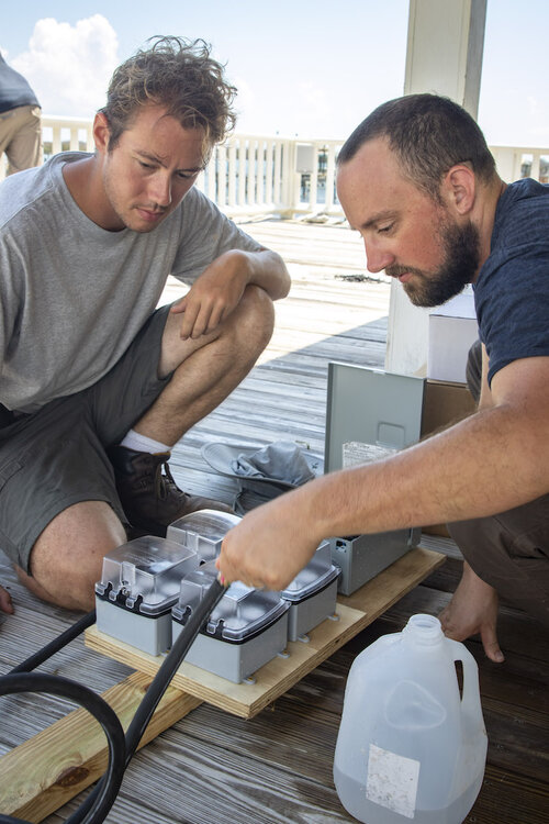 Chris Mobley (left) is now volunteering with Water Mission. Photo Credit: Water Mission