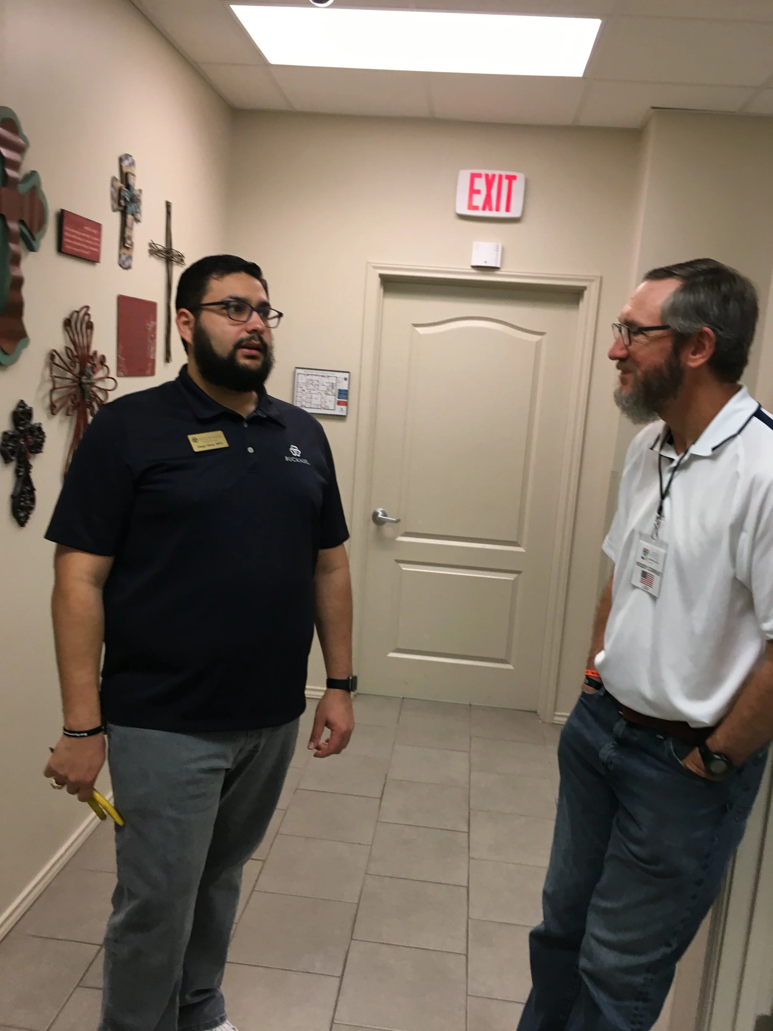 Diego Silva (left), director of Buckner International’s Family Hope Center in Peñitas, Texas, visits with Woody Conradt, a lay member of Valley Ranch Baptist Church in Coppell, Texas, before the center’s economic strengthening program classes kick off during spring break.