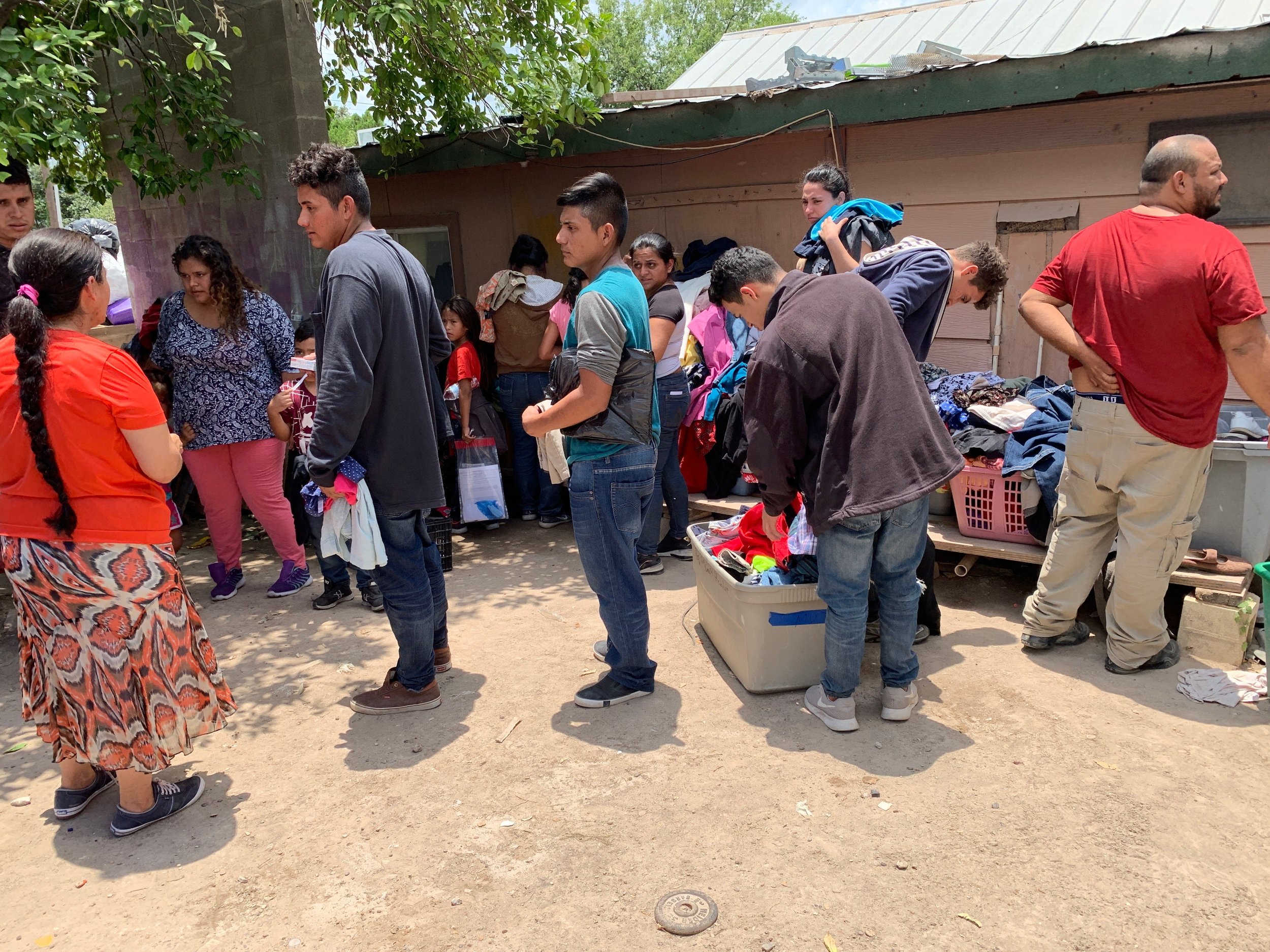 Here are the refugees in the backyard of pastor Ortiz's house looking for clothes before they shower.