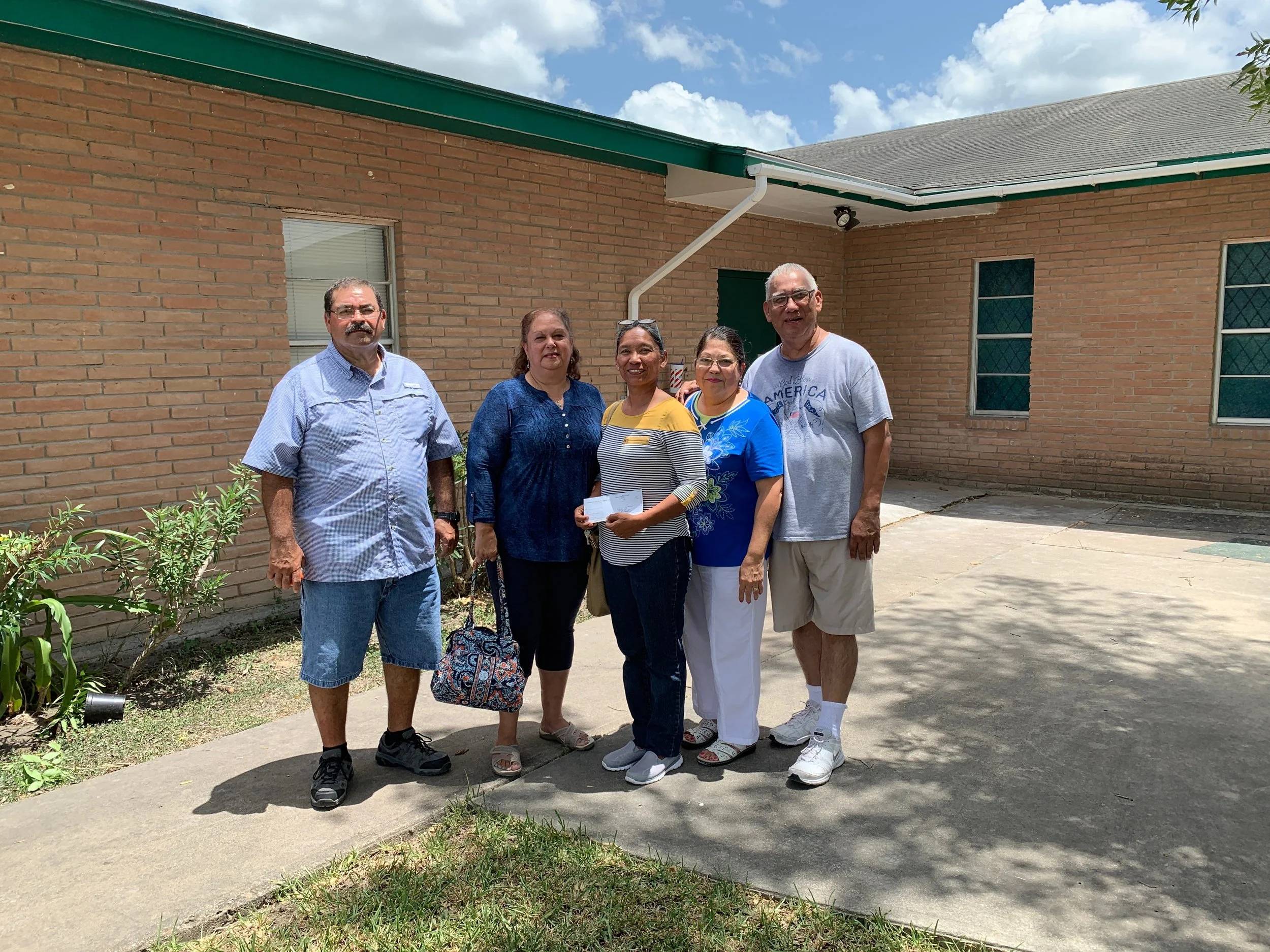 Pastor Roberto Reyes (right) and leaders of Iglesia Bautista Avondale in Harlingen, Texas, expressed thanks for disaster-recovery funds provided by CBF. The money is helping the church acquire supplies to repair its facilities, damaged in a summer flood.