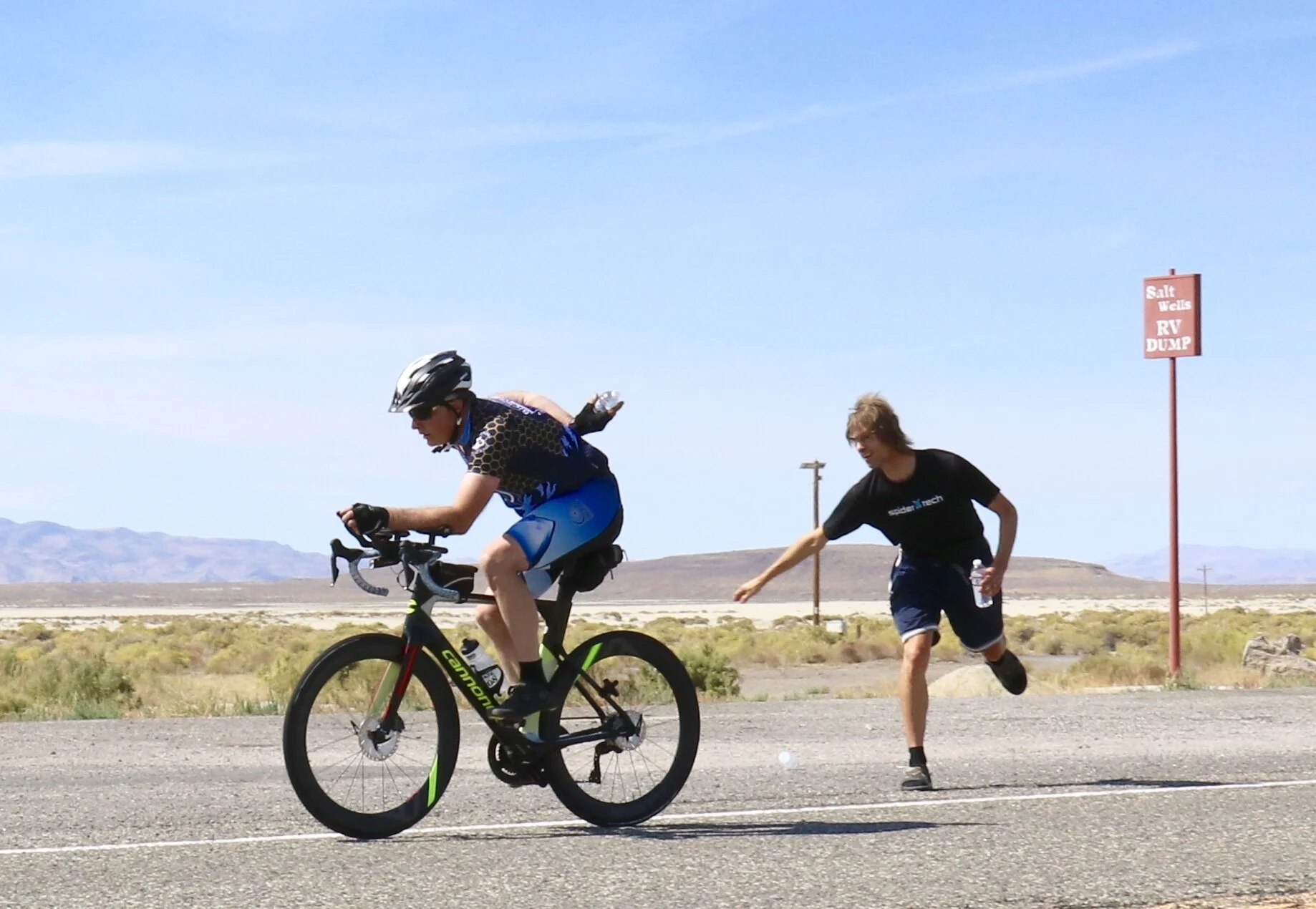 Mike handing off a water bottle at speed. You can see the water bottle in my hand on my back.