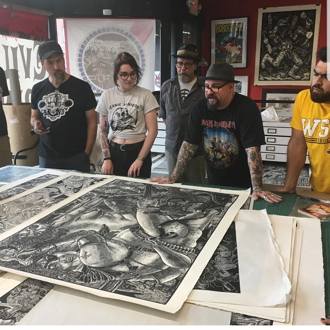 I love this photograph. We four bootcampers are intensely examining a dog penis that took Huck several days to carve in this print that was part of the Bloody Bucket series. (pic by Shannon Cousino)