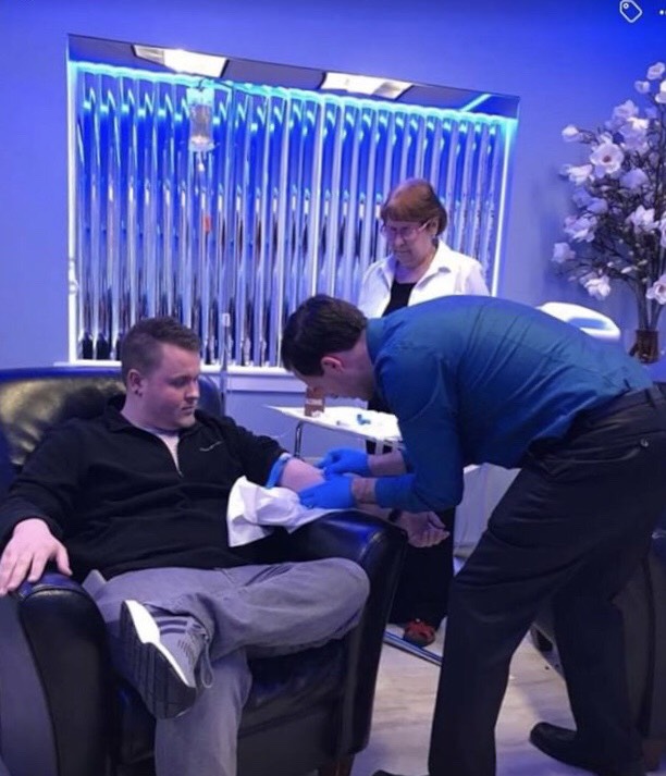 Austin, our office manager, receiving IV Vitamin Infusion from Dr. Eric, our Naturopath Physician and Tani our nurse