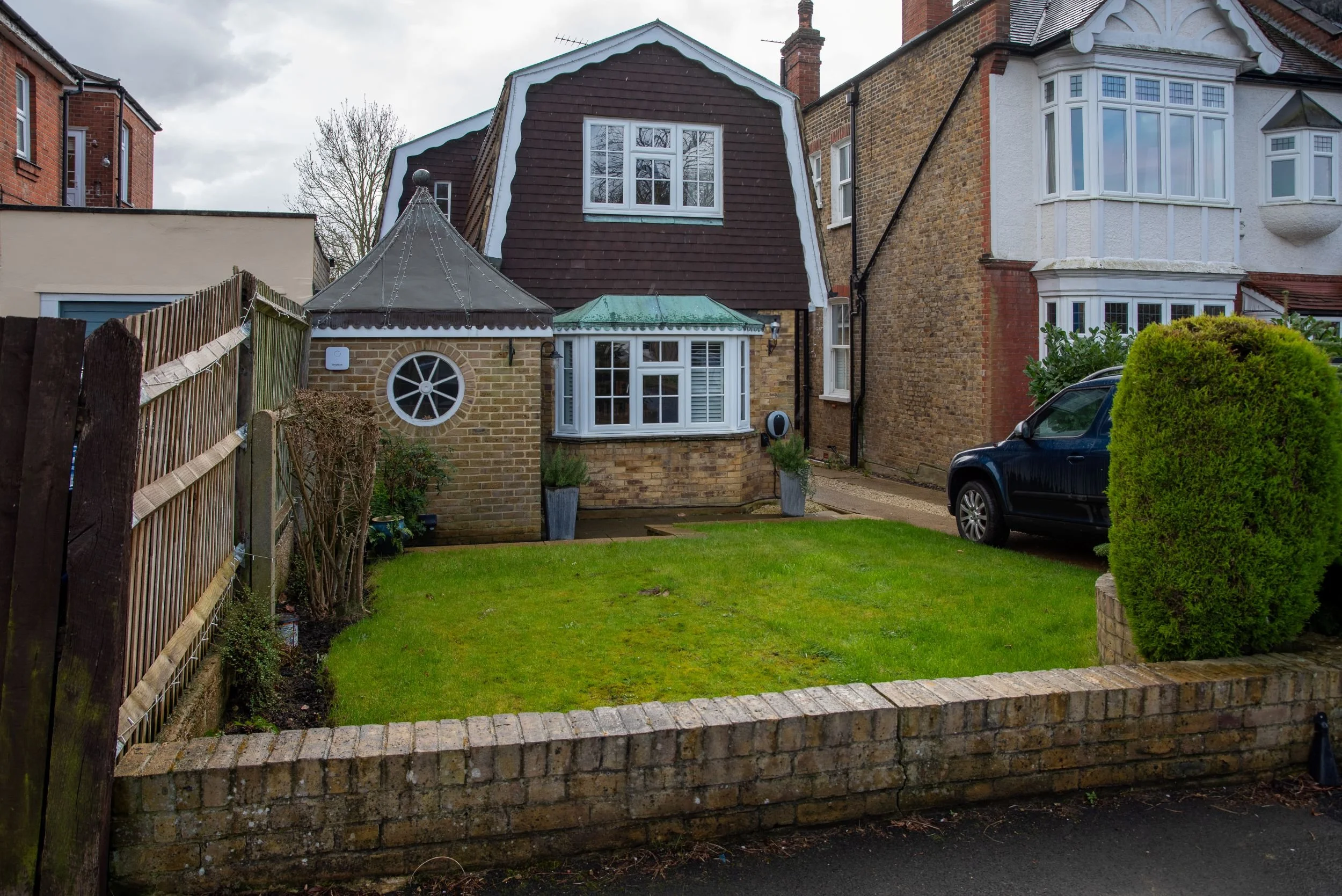 The Raynes Park front garden before its redesign, showing a plain lawn and bare borders in front of the house. JaneShanksterGardenDesign.co.uk

Before the transformation, the front garden was little more than a plain rectangle of lawn edged by a low 