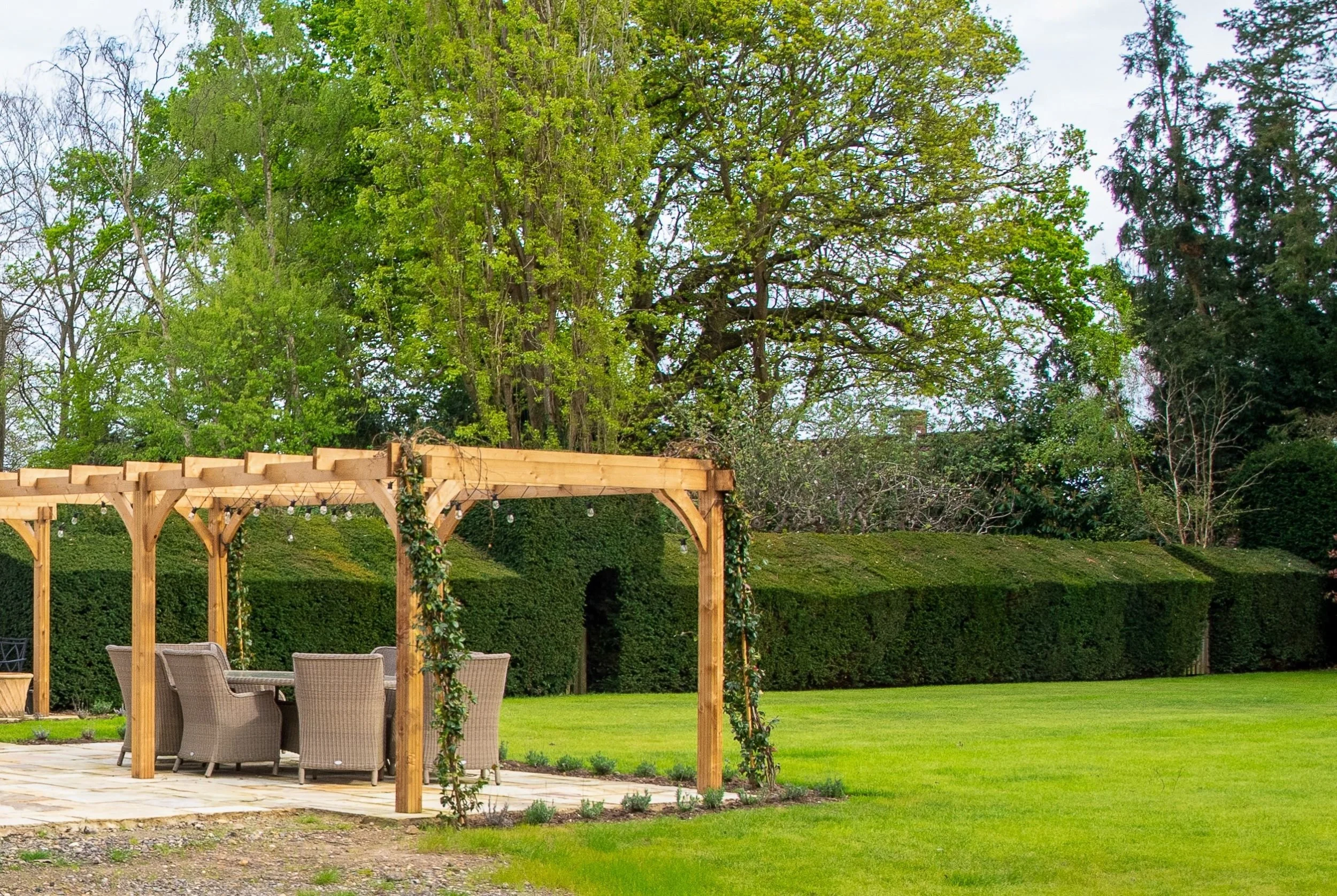 Pergola with exisitng newly planted lavender still establishing, Surrey garden by Jane Shankster Garden Design

The same pergola and terrace shortly after planting, with existing new lavender still establishing themselves along the border edge. This 