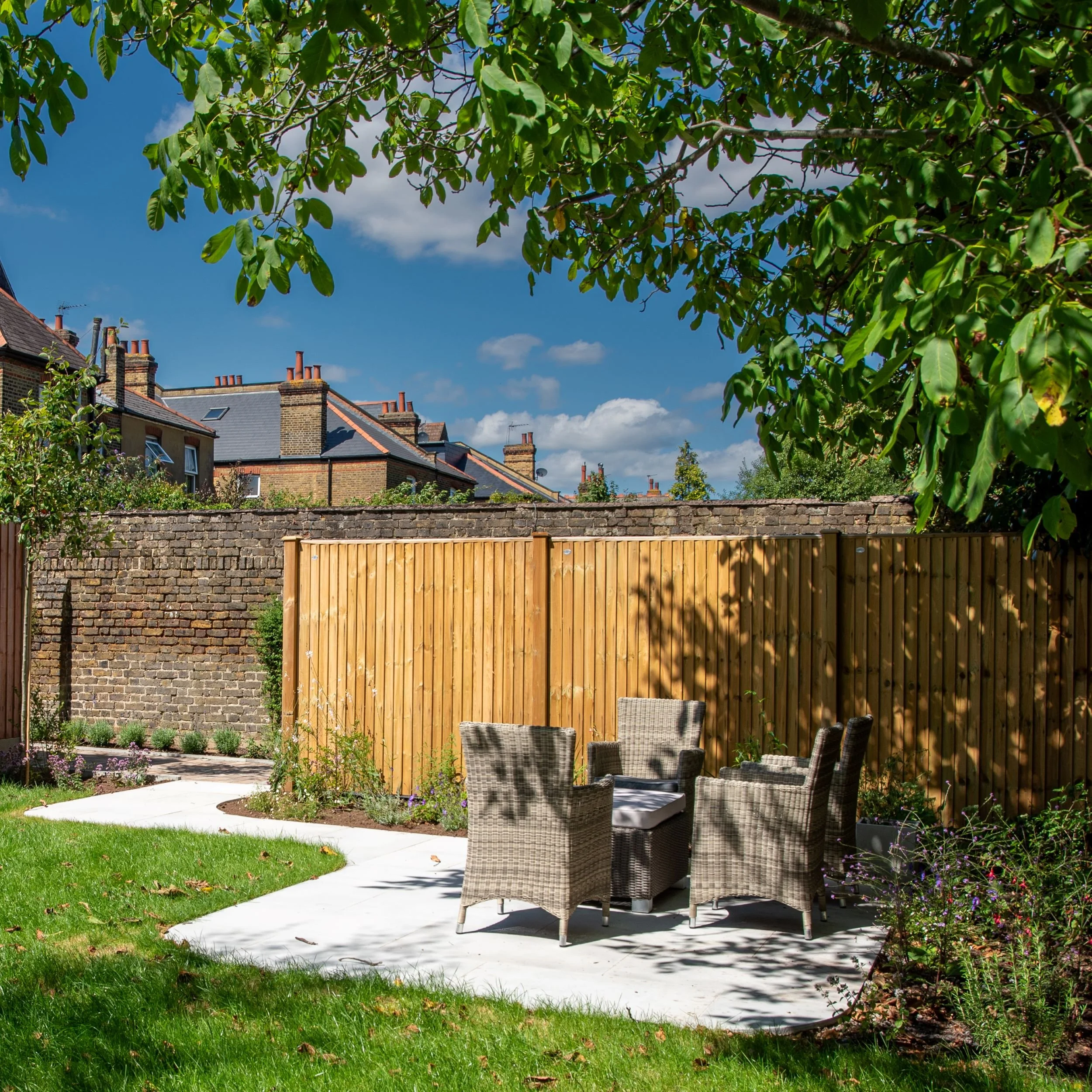 Communal garden with lawn, paving and seating area, property development

A spacious communal garden designed for a property development, combining sweeping lawn, curved stone pathways, and a sheltered rattan seating area. Timber fencing and reclaime