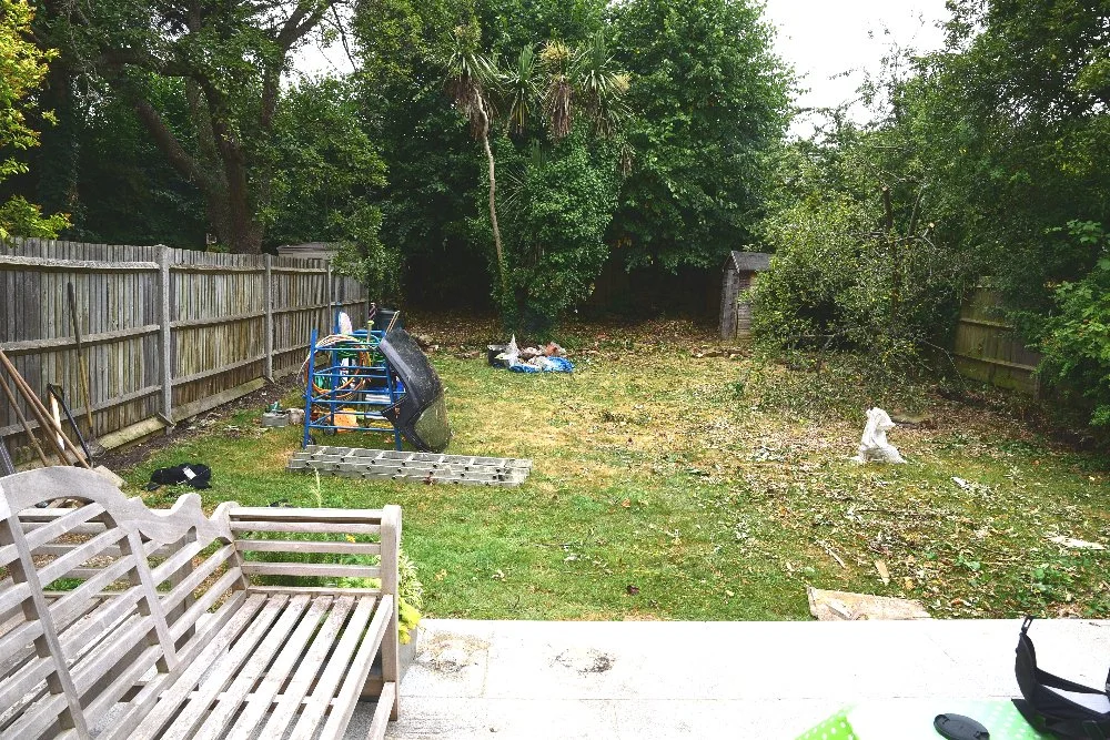Overgrown garden before landscaping, Wimbledon entertaining garden

The garden before its transformation, showing an overgrown lawn, mismatched fencing, and scattered storage items awaiting clearance. This before shot highlights the scale of change a